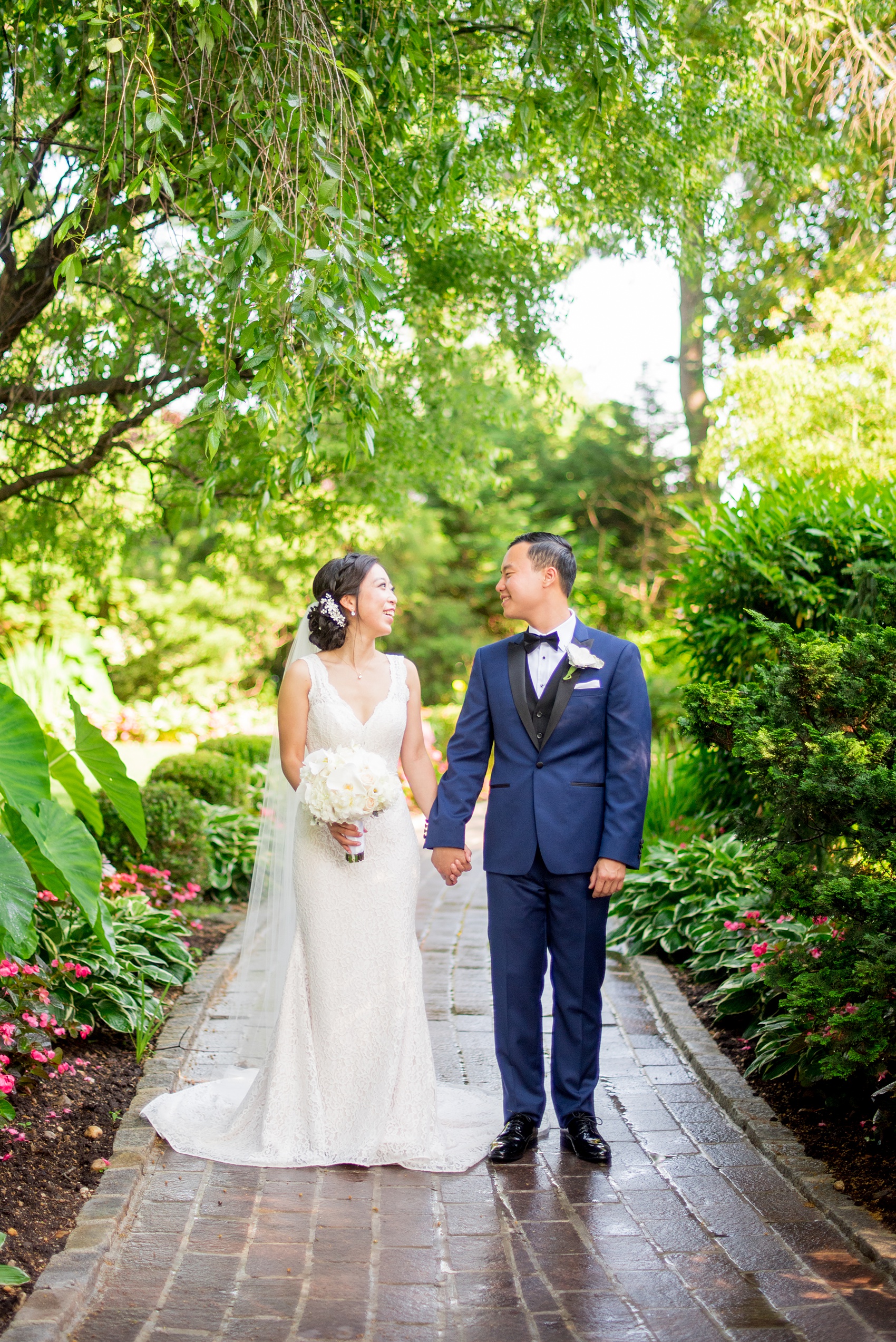 Mikkel Paige Photography pictures of a Westbury Manor wedding on Long Island. Photo of the bride and groom in the garden.