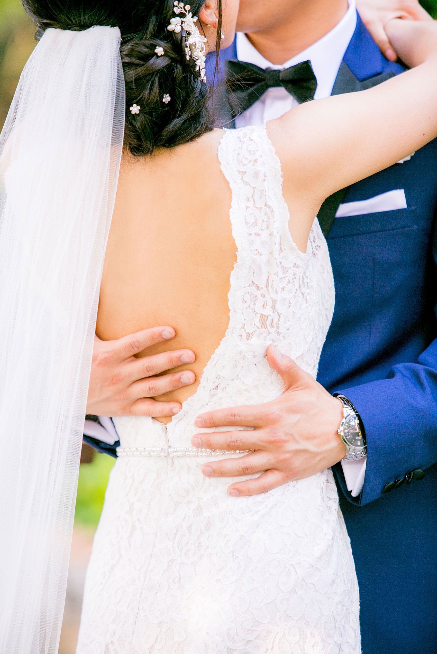 Mikkel Paige Photography pictures of a Westbury Manor wedding on Long Island. Up close photo of the groom hugging his bride.