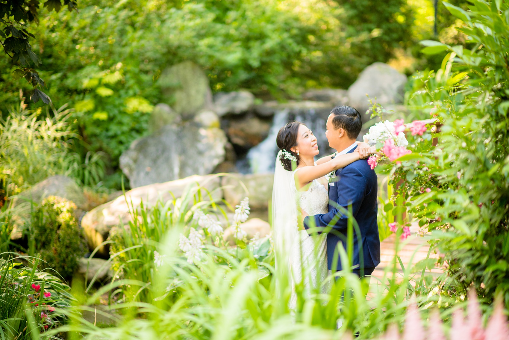 Mikkel Paige Photography pictures of a Westbury Manor wedding on Long Island. Photo of the bride and groom in the garden.