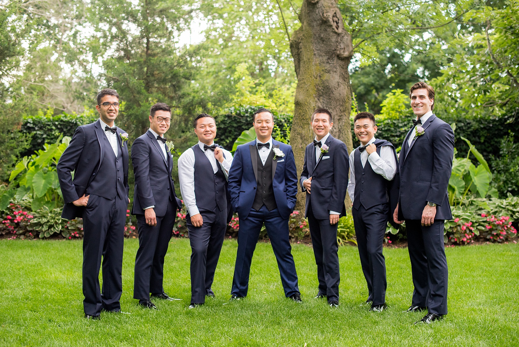 Mikkel Paige Photography pictures of a Westbury Manor wedding on Long Island. Photo of the groomsmen in navy suits and bow ties.