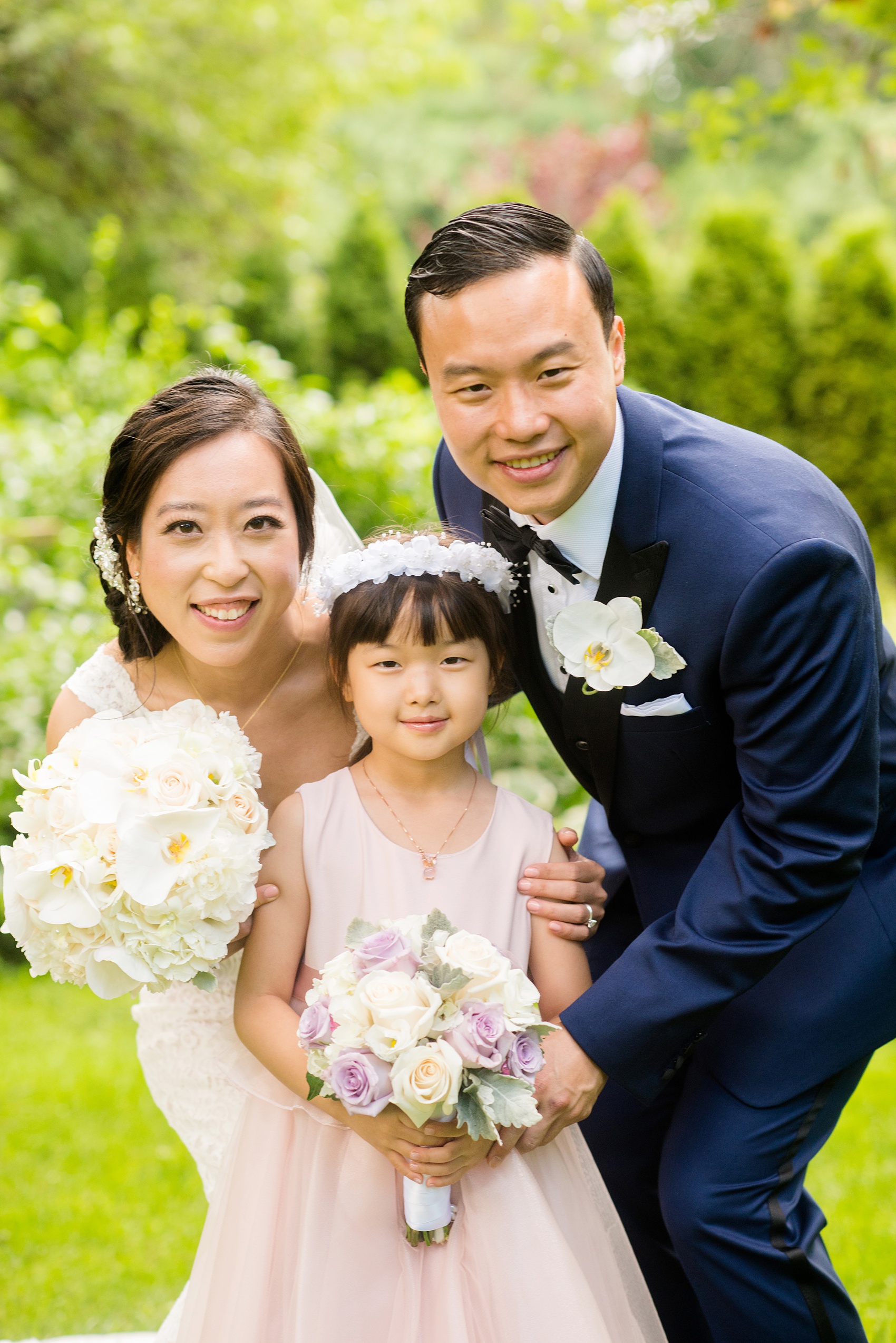 Mikkel Paige Photography pictures of a Westbury Manor wedding on Long Island. Photo of the bride, groom and their flower girl.