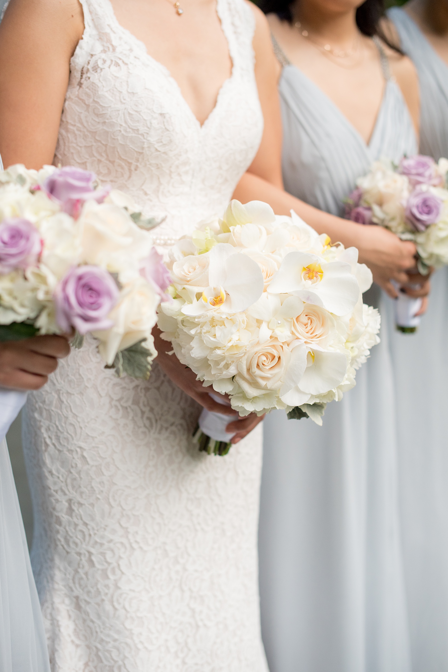 Mikkel Paige Photography pictures of a Westbury Manor wedding on Long Island. Detail photo of the bride and bridesmaids white orchid, hydrangea and rose bouquet.