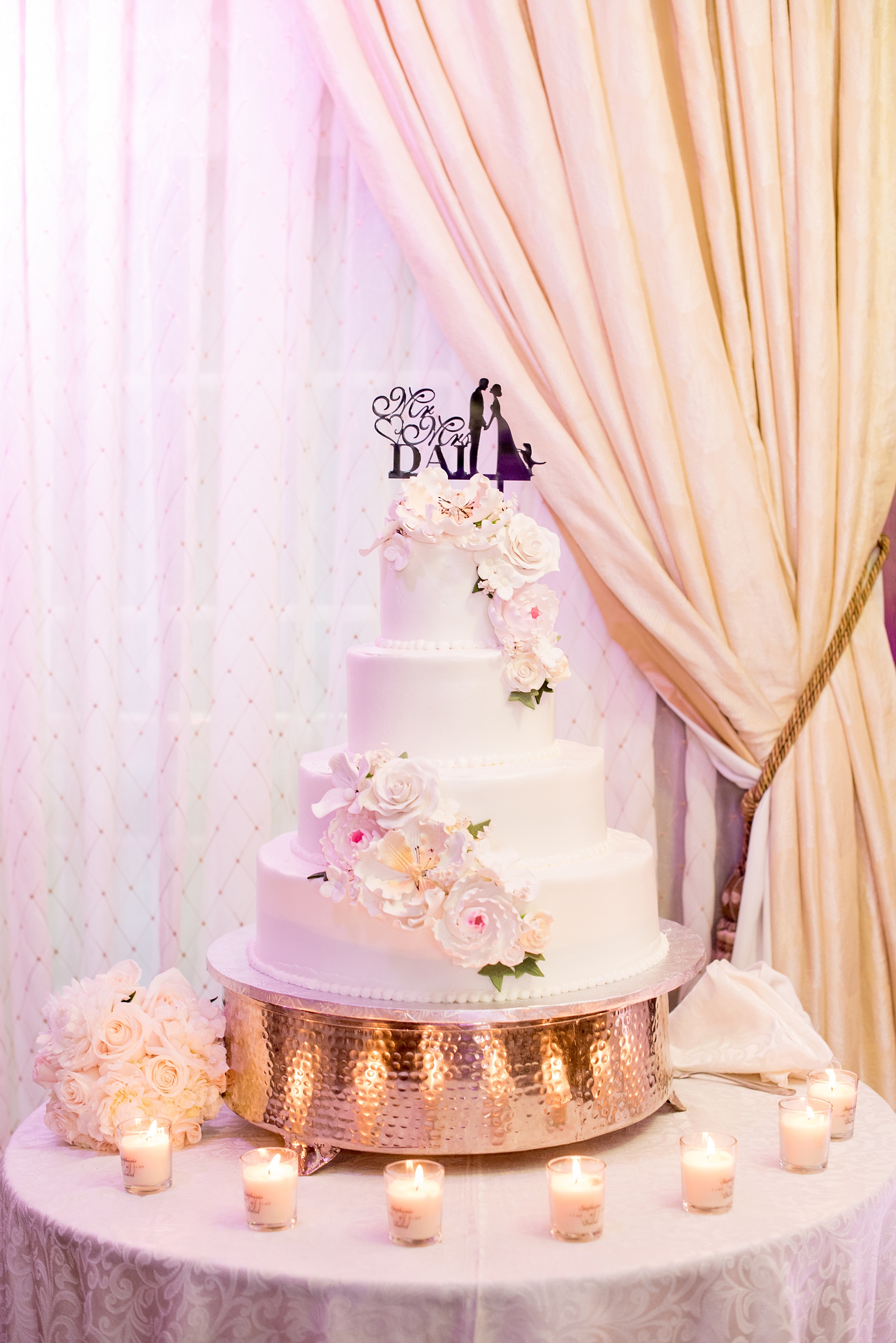 Mikkel Paige Photography pictures of a Westbury Manor wedding on Long Island. White tiered fondant cake with cascading gumpaste flowers.