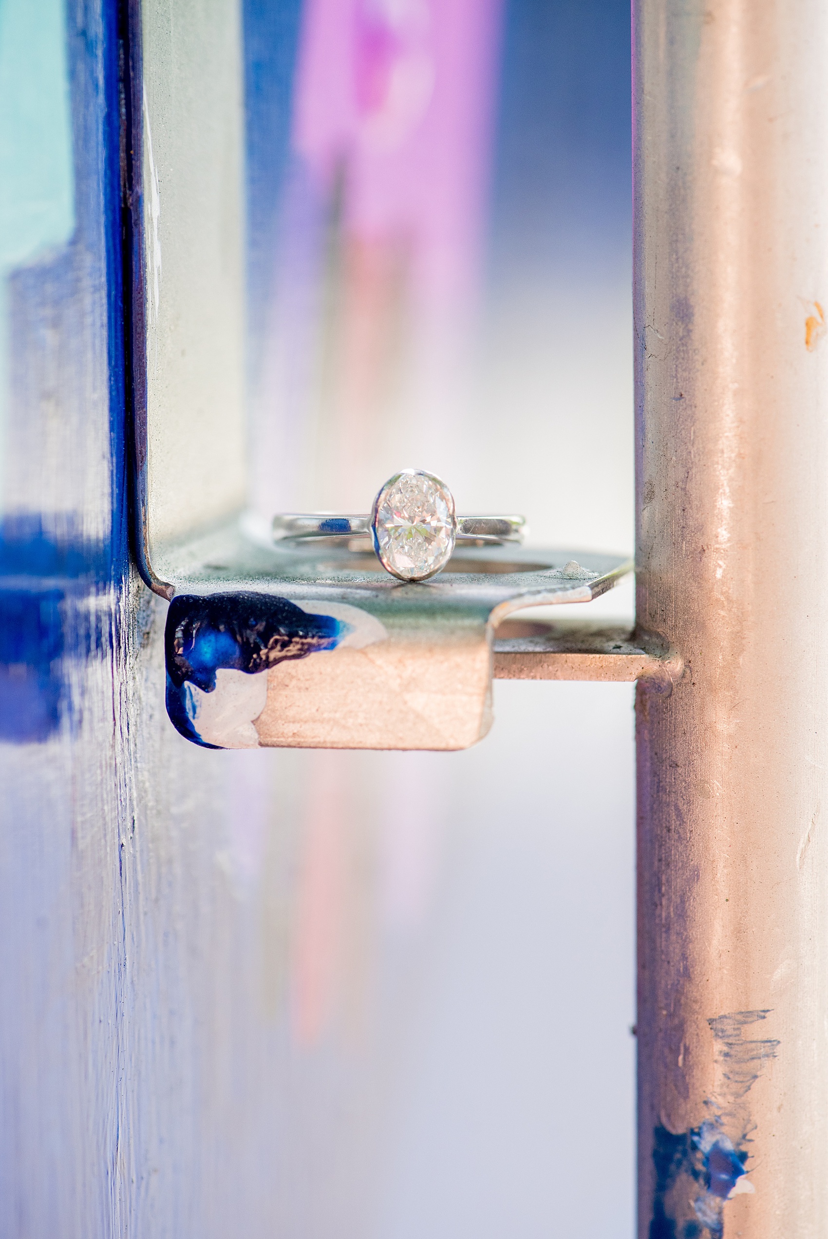 Mikkel Paige Photography pictures of a colorful engagement session in Chapel Hill North Carolina. Photo of the bride's oval diamond engagement ring in a modern setting.