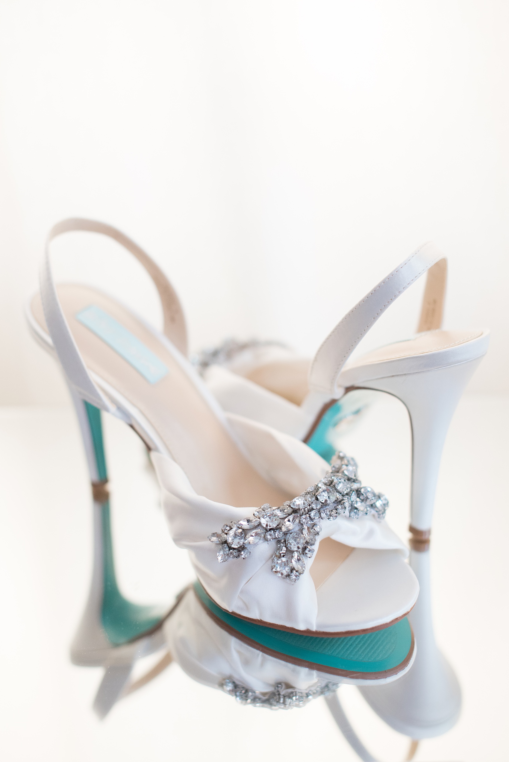 Mikkel Paige Photography pictures of a wedding at Leslie-Alford Mim's House in North Carolina for a Mad Dash Weddings event. Photo of the bride's blue-soled Betsey Johnson rhinestone bridal day shoes.