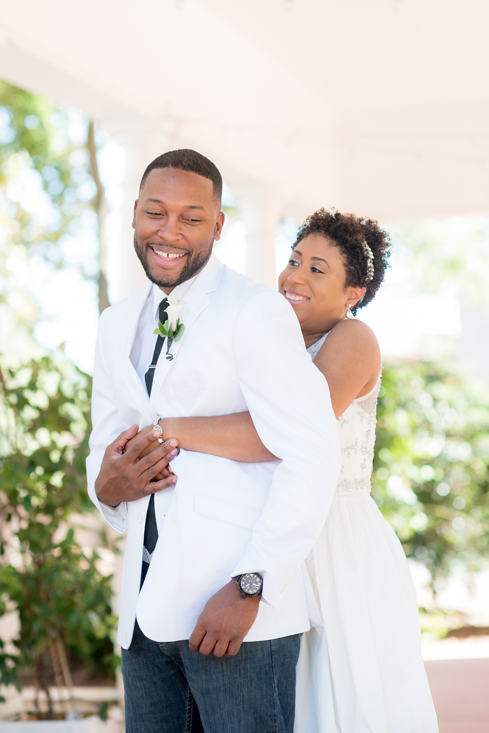 Mikkel Paige Photography pictures of a wedding at Leslie-Alford Mim's House in North Carolina for a Mad Dash Weddings event. Photo of the bride hugging the groom! 