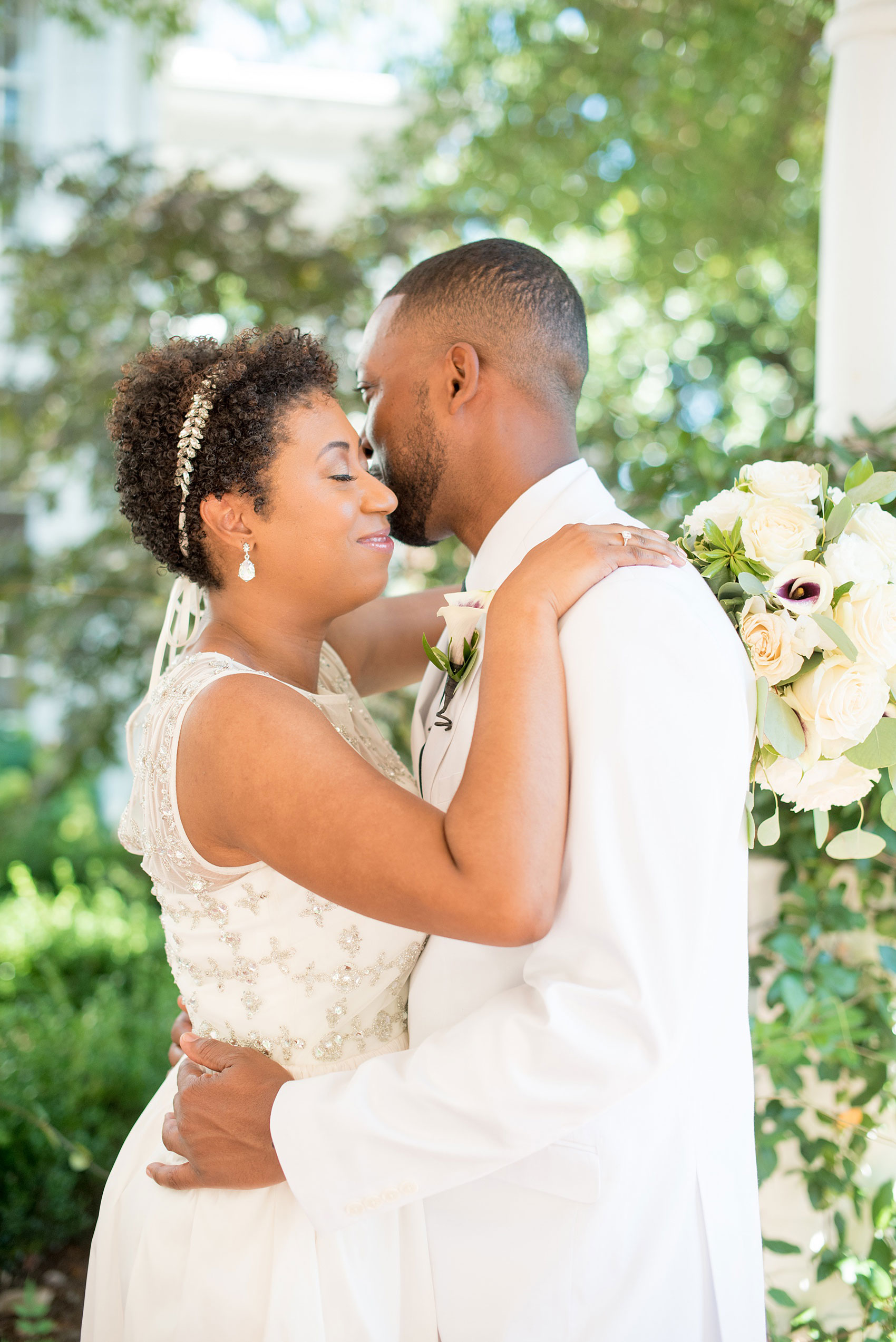 Mikkel Paige Photography pictures of a wedding at Leslie-Alford Mim's House in North Carolina for a Mad Dash Weddings event. Photo of the bride and groom embracing in the garden.