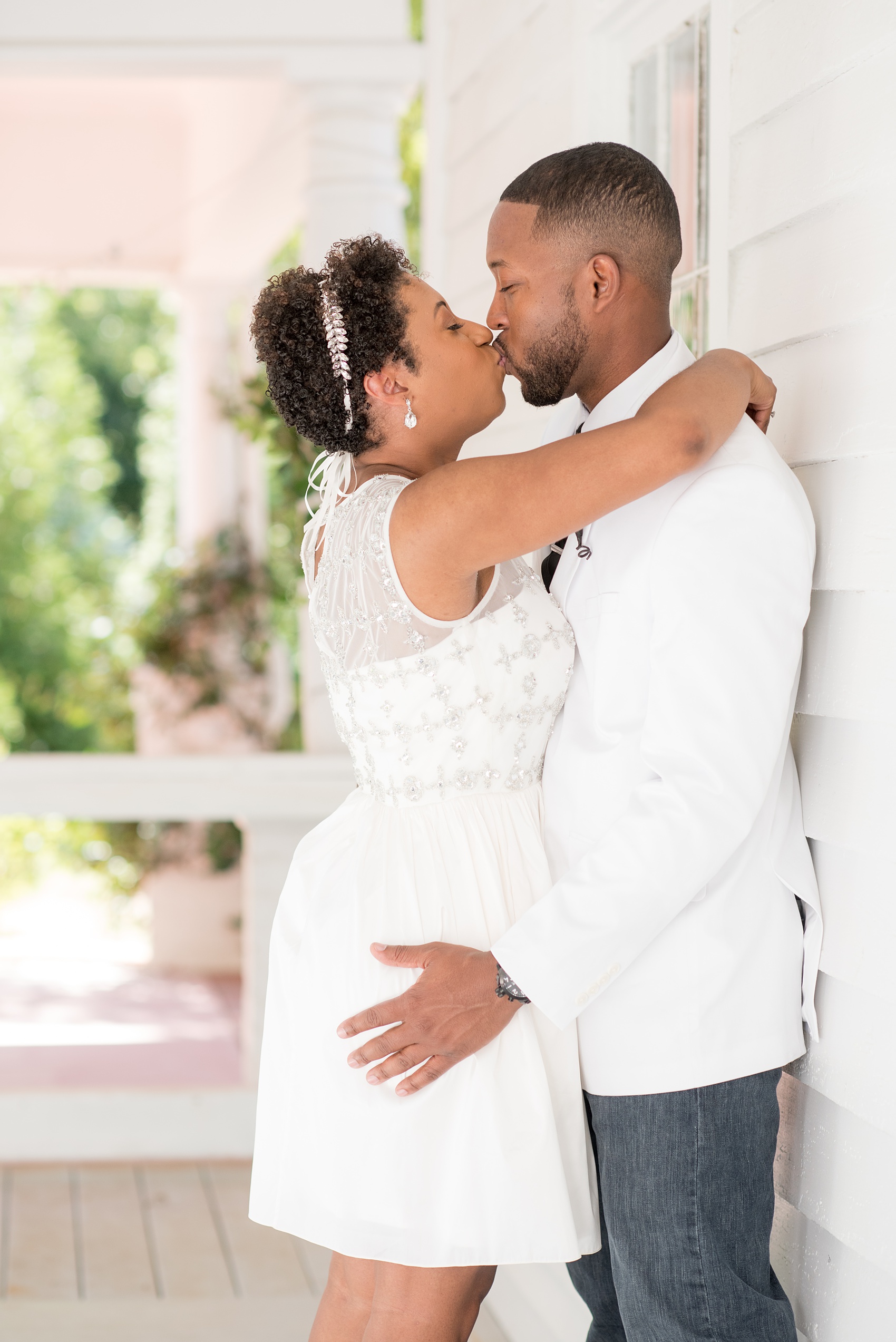 Mikkel Paige Photography pictures of a wedding at Leslie-Alford Mim's House in North Carolina for a Mad Dash Weddings event. Photo of the bride and groom kissing near the historic home.