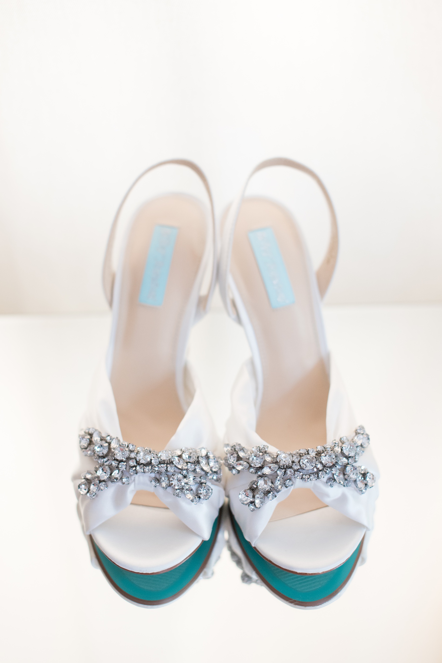 Mikkel Paige Photography pictures of a wedding at Leslie-Alford Mim's House in North Carolina for a Mad Dash Weddings event. Photo of the bride's blue-soled Betsey Johnson rhinestone bridal day shoes.