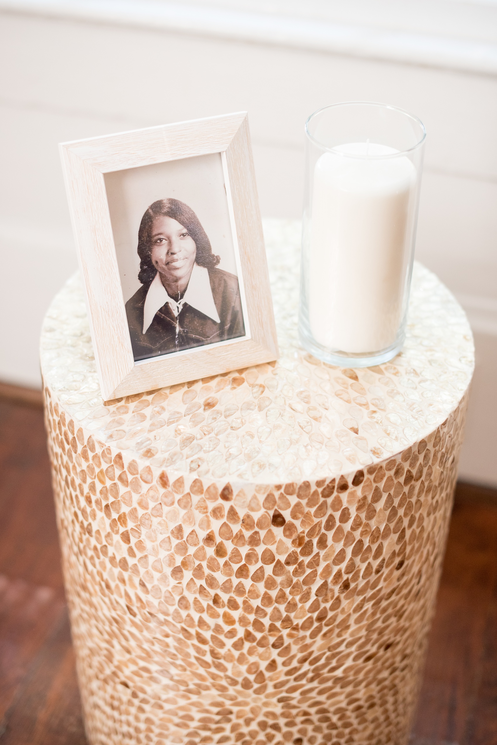 Mikkel Paige Photography pictures of a wedding at Leslie-Alford Mim's House in North Carolina for a Mad Dash Weddings event. Photo of the groom's mother's photo and remembrance candle on a side table in the ceremony room. 