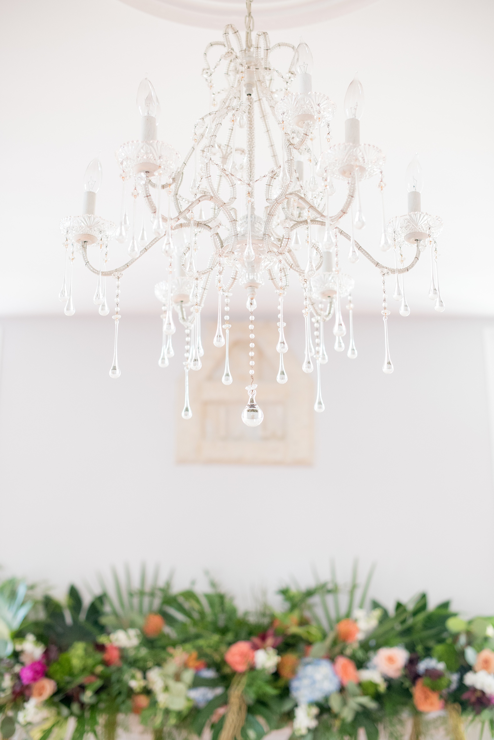 Mikkel Paige Photography pictures of a wedding at Leslie-Alford Mim's House in North Carolina for a Mad Dash Weddings event. Photo of the glass chandelier hanging in the ceremony space.