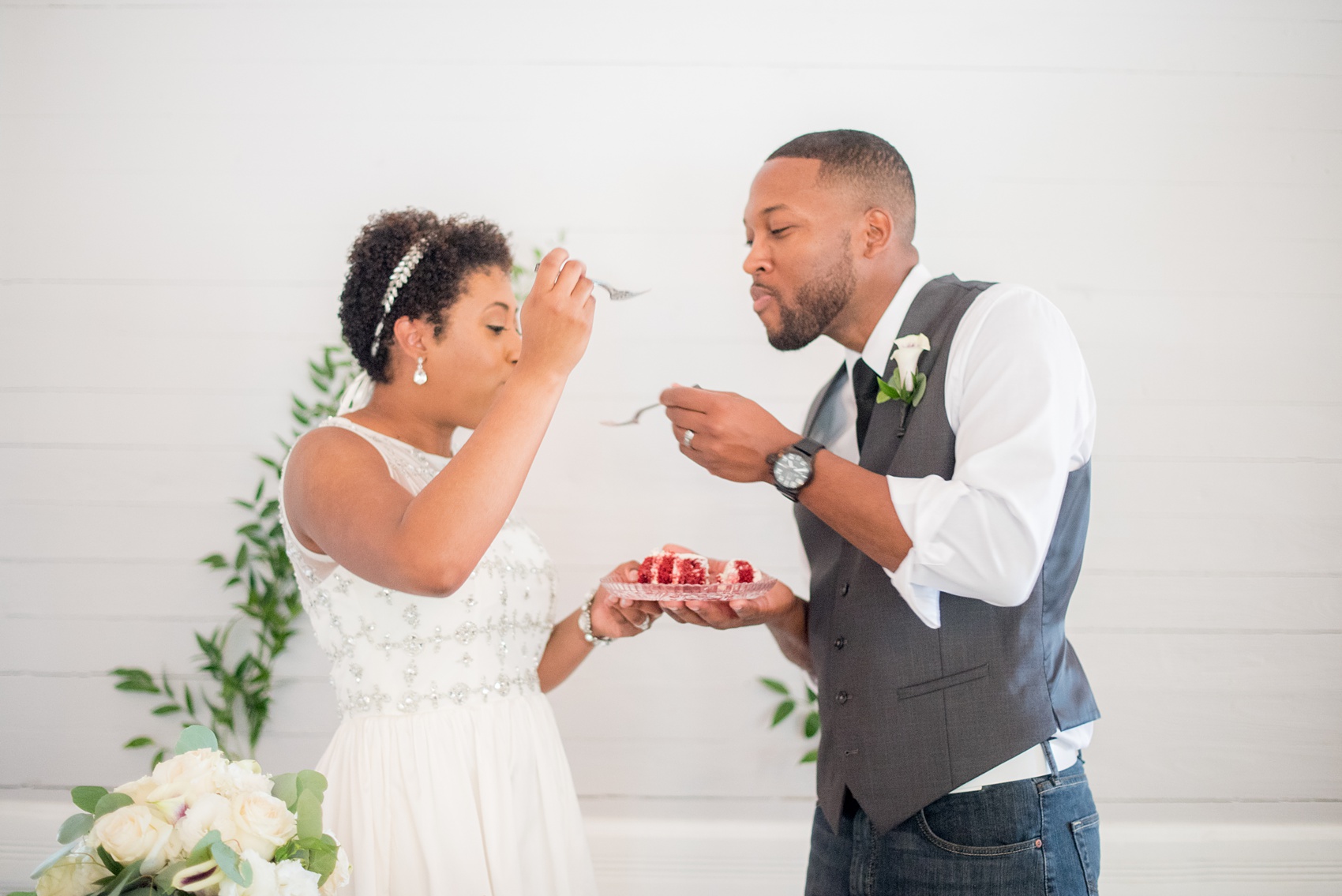 Mikkel Paige Photography pictures of a wedding at Leslie-Alford Mim's House in North Carolina for a Mad Dash Weddings event. Photo of the couple's cake cutting and red velvet cake. 