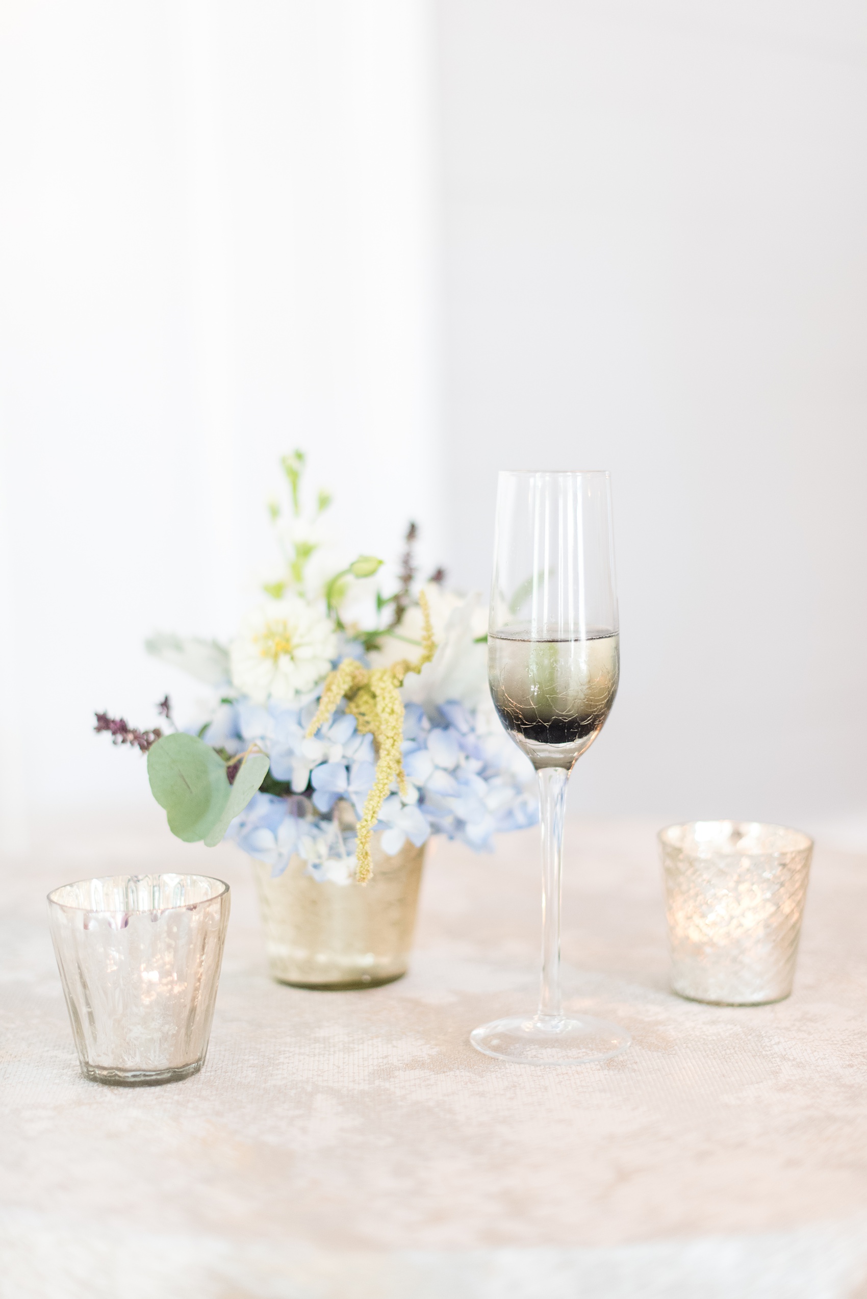 Mikkel Paige Photography pictures of a wedding at Leslie-Alford Mim's House in North Carolina for a Mad Dash Weddings event. Photo of the reception setup and smoky glass champagne flutes. 