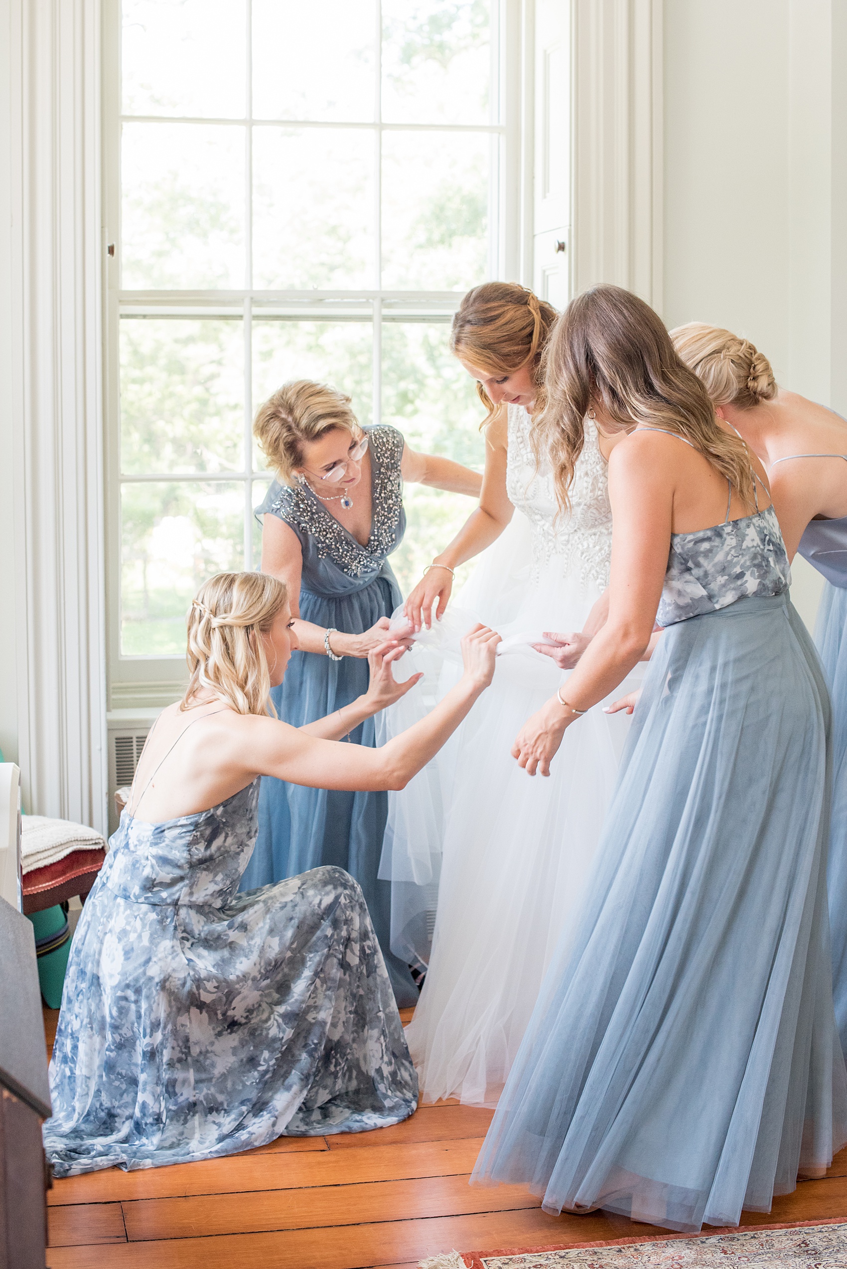 Mikkel Paige Photography photos from a Southwood Estate Wedding in Germantown, New York in the Hudson Valley. Picture of the bridesmaids helping the bride get ready in the historic home.