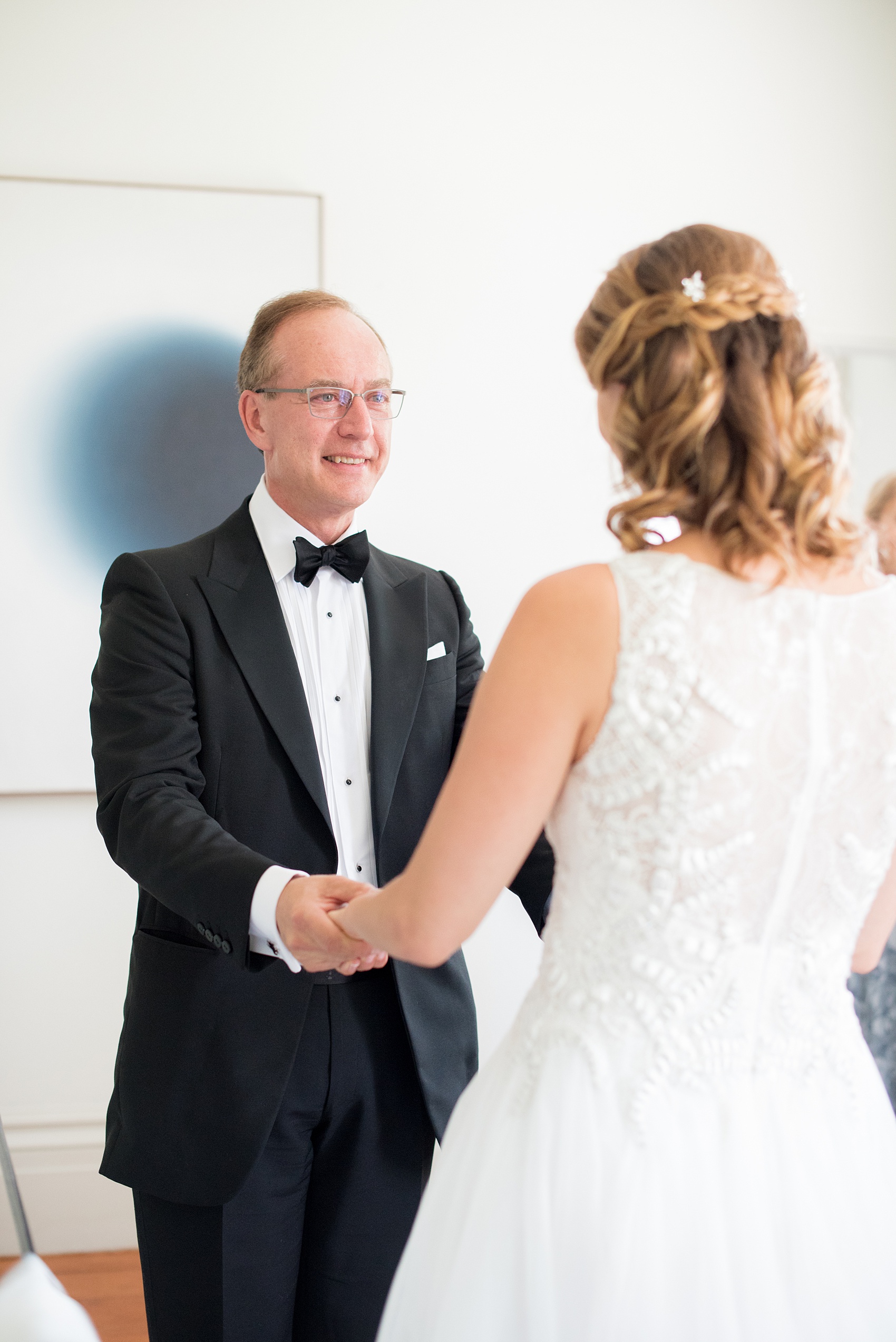 Mikkel Paige Photography photos from a Southwood Estate Wedding in Germantown, New York in the Hudson Valley. Picture of the bridesmaids helping the bride's father's first look with his daughter.