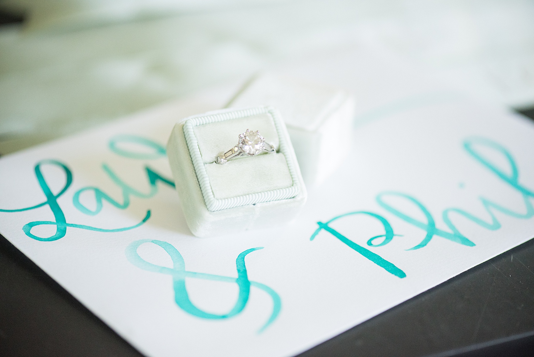 Mikkel Paige Photography photos from a Southwood Estate Wedding in Germantown, New York in the Hudson Valley. Picture of the bride's engagement ring in a mint green Mrs. Box.