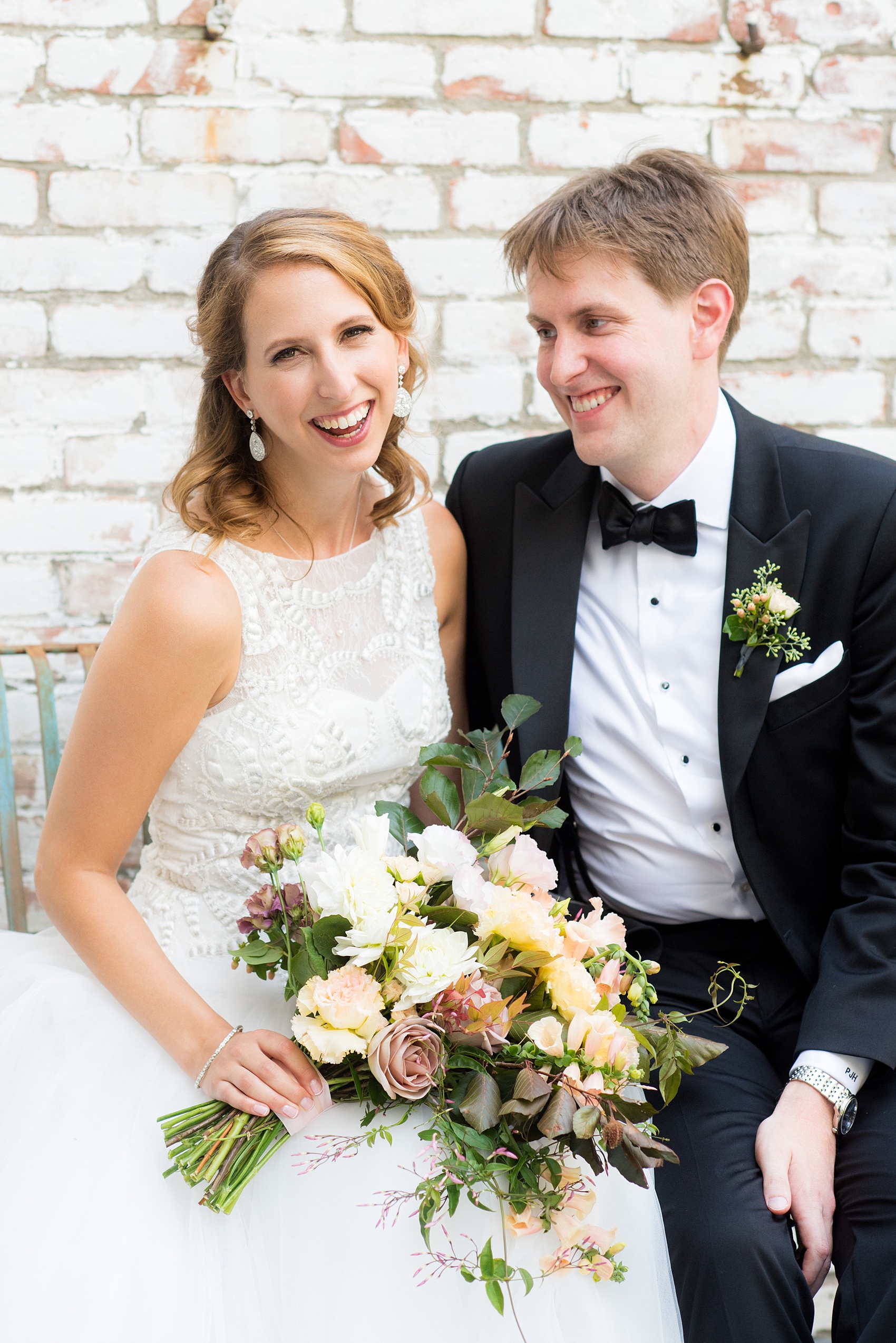 Mikkel Paige Photography photos from a Southwood Estate Wedding in Germantown, New York in the Hudson Valley. Picture of the bride and groom on the front porch against white bricks.