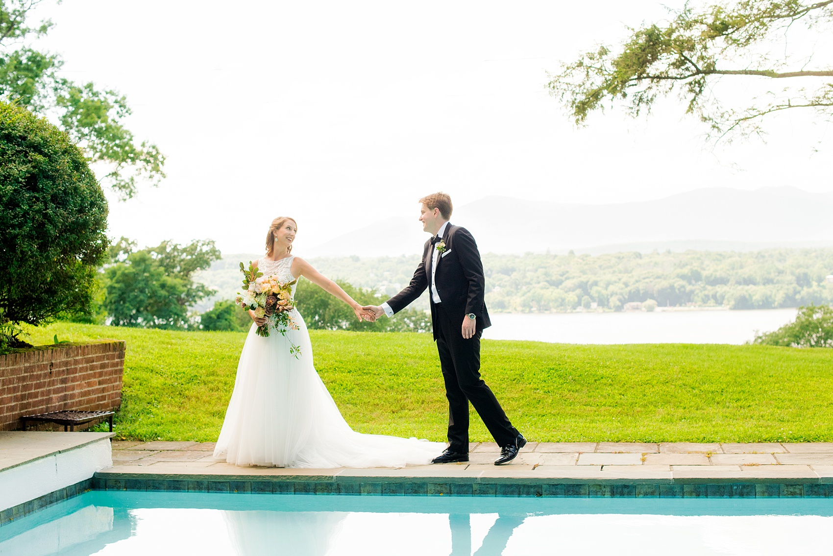 Mikkel Paige Photography photos from a Southwood Estate Wedding in Germantown, New York in the Hudson Valley. Picture of the bride and groom by the pool on the historic property.