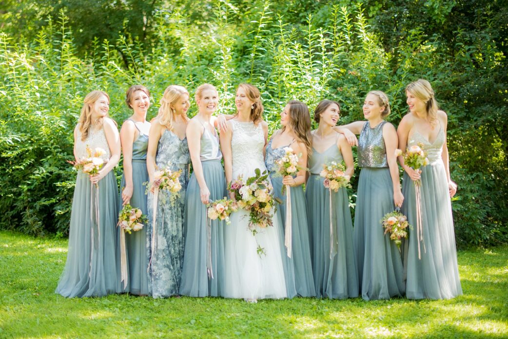 Mikkel Paige Photography photos from a Southwood Estate Wedding in Germantown, New York in the Hudson Valley. Picture of the bride and her bridal party. Her bridesmaids wore cornflower blue skirts with mismatched tops.