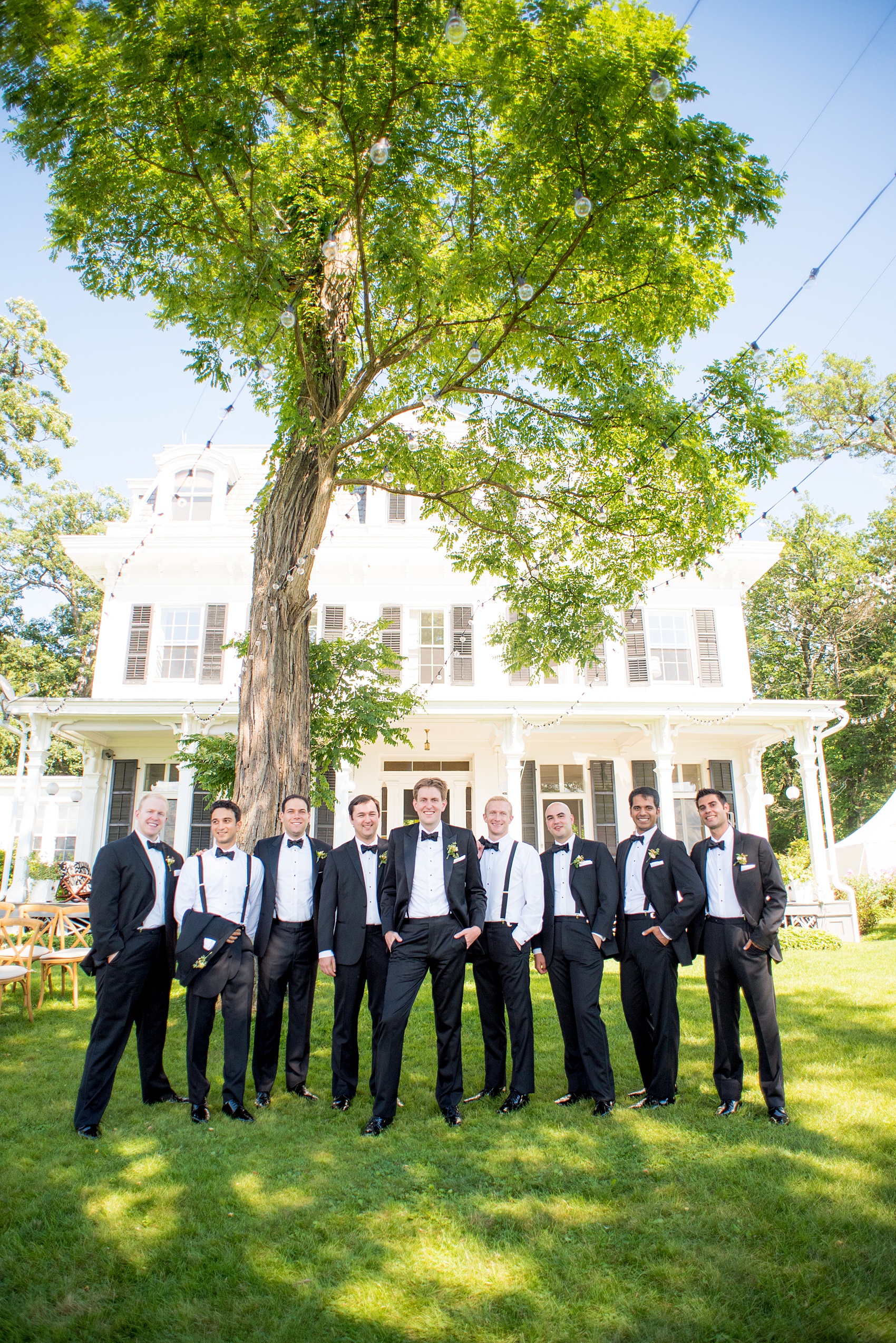 Mikkel Paige Photography photos from a Southwood Estate Wedding in Germantown, New York in the Hudson Valley. Creative picture of the groomsmen in classic black tuxedos and bow ties in front of the historic home.