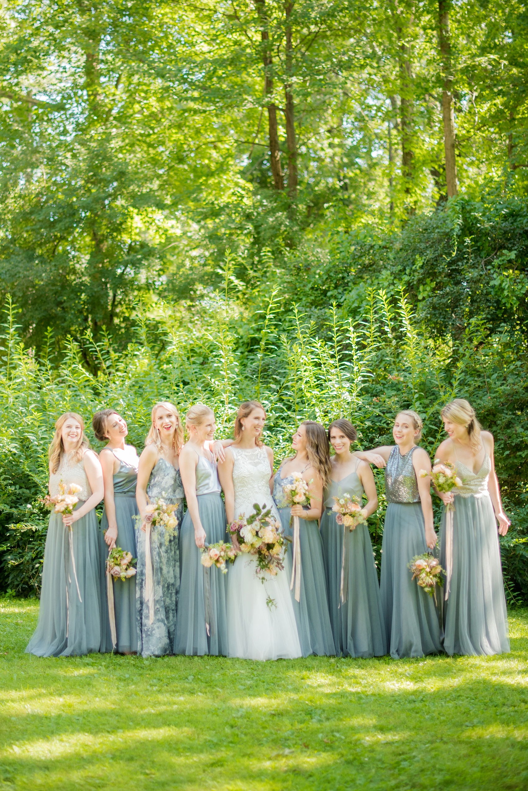 Mikkel Paige Photography photos from a Southwood Estate Wedding in Germantown, New York in the Hudson Valley. Creative picture of the bride and her bridal party. Her bridesmaids wore cornflower blue skirts with mismatched tops.