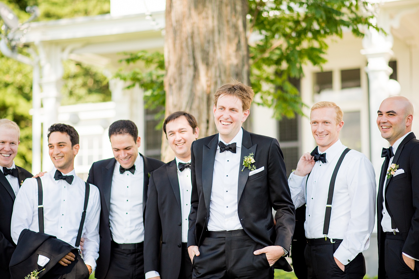 Mikkel Paige Photography photos from a Southwood Estate Wedding in Germantown, New York in the Hudson Valley. Creative picture of the groomsmen in classic black tuxedos and bow ties in front of the historic home.