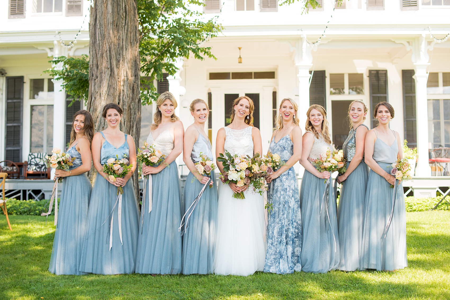 Mikkel Paige Photography photos from a Southwood Estate Wedding in Germantown, New York in the Hudson Valley. Picture of the bride and her bridal party. Her bridesmaids wore cornflower blue skirts with mismatched tops.