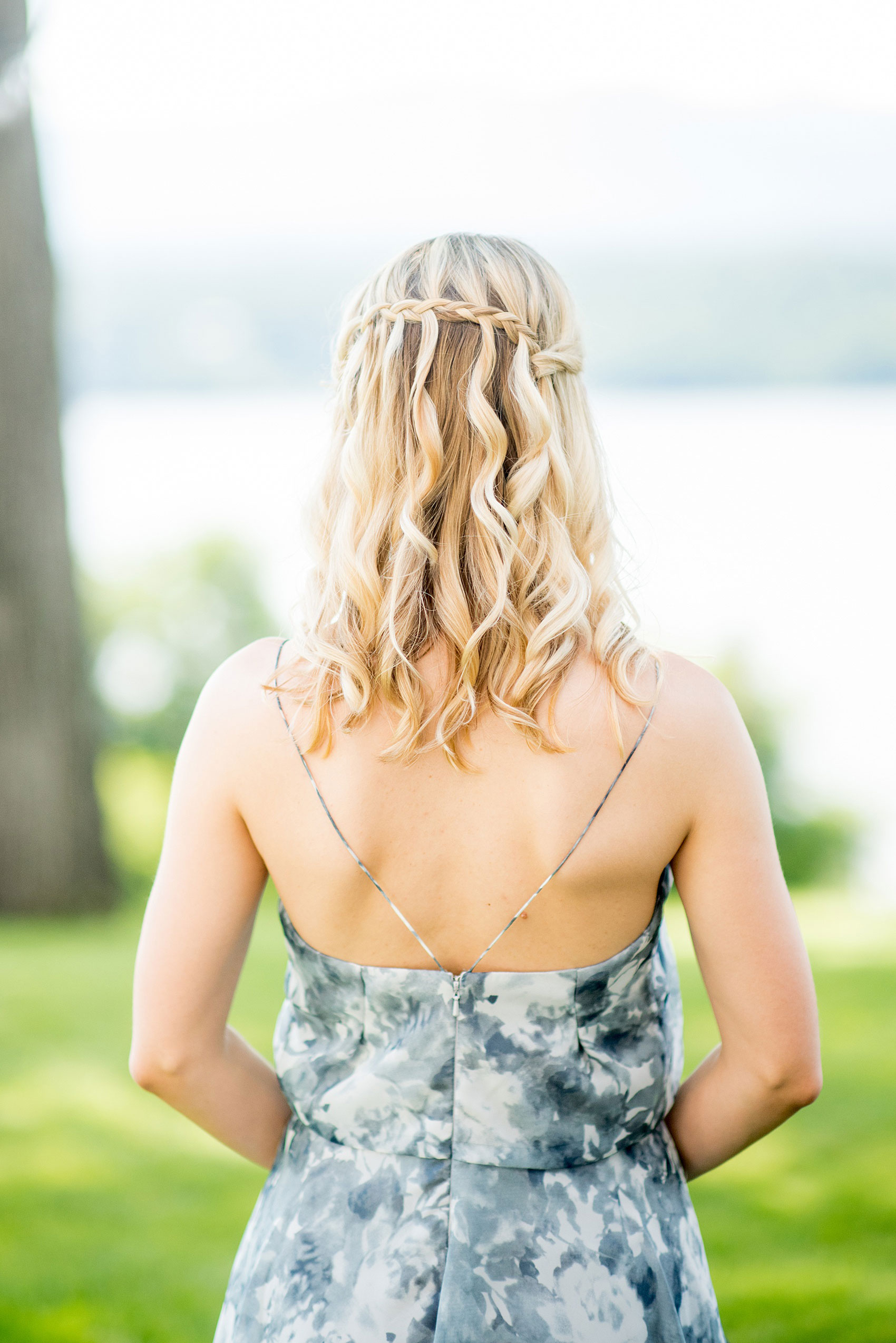 Mikkel Paige Photography photos from a Southwood Estate Wedding in Germantown, New York in the Hudson Valley. Picture of the maid of honor in a blue floral gown with her cascading waterfall braid hair style.