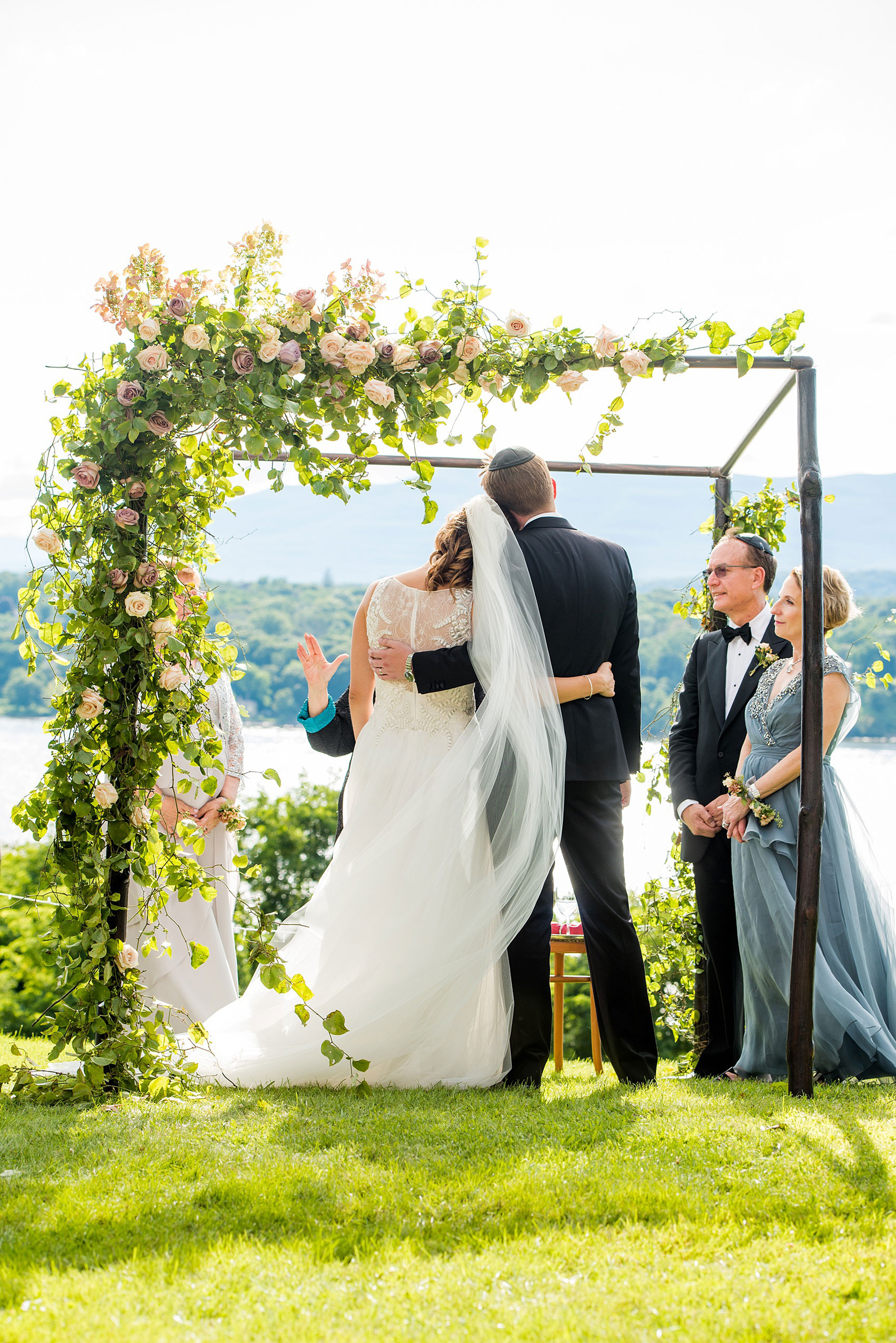 Mikkel Paige Photography photos from a Southwood Estate Wedding in Germantown, New York in the Hudson Valley. Picture of the bride and groom under the chuppah during the ceremony overlooking the Hudson Valley mountains and river.