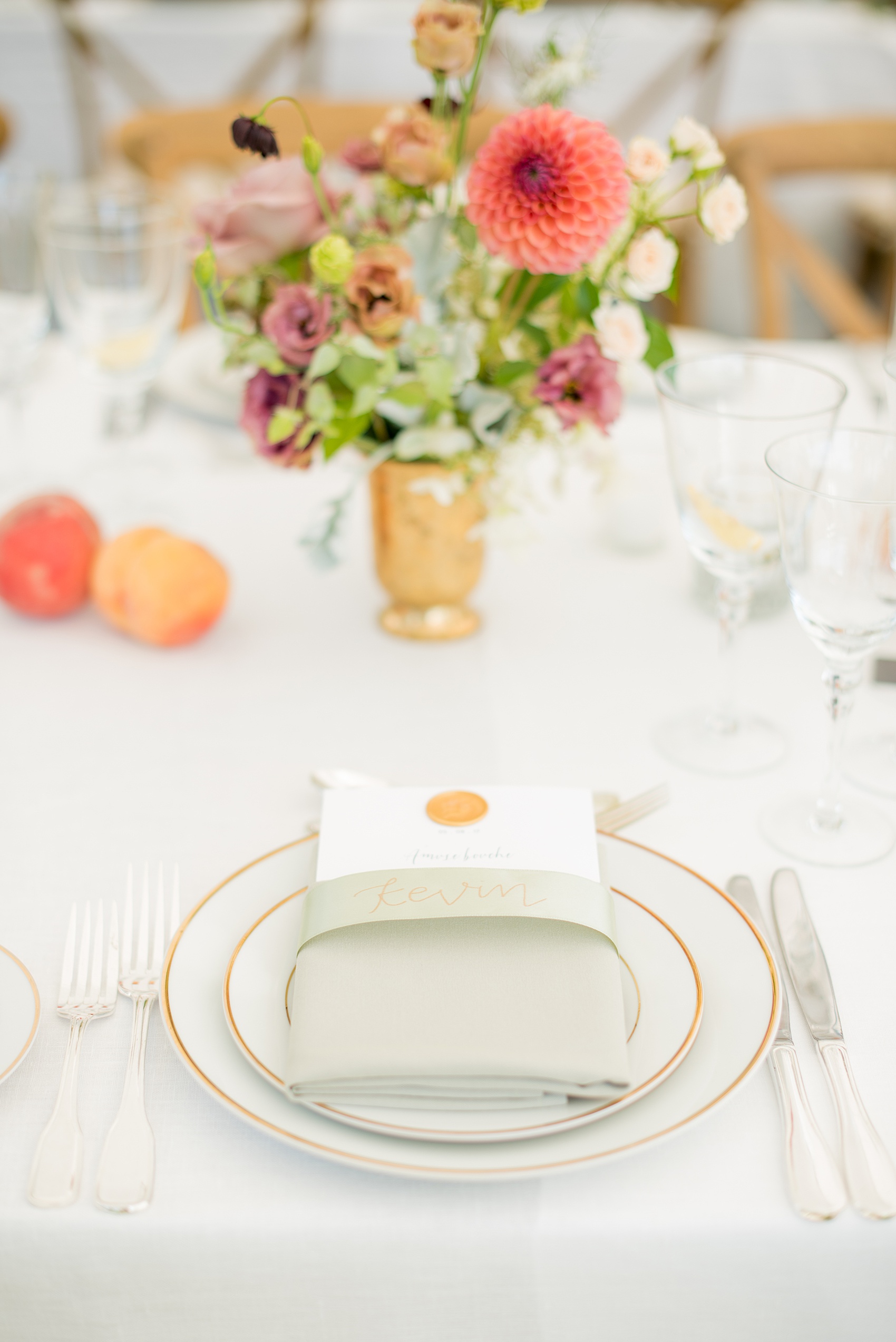 Mikkel Paige Photography photos from a Southwood Estate Wedding in Germantown, New York in the Hudson Valley. Picture of the custom menu ribbon place cards and wax seal menu cards in the reception tent with peach and light green colors.