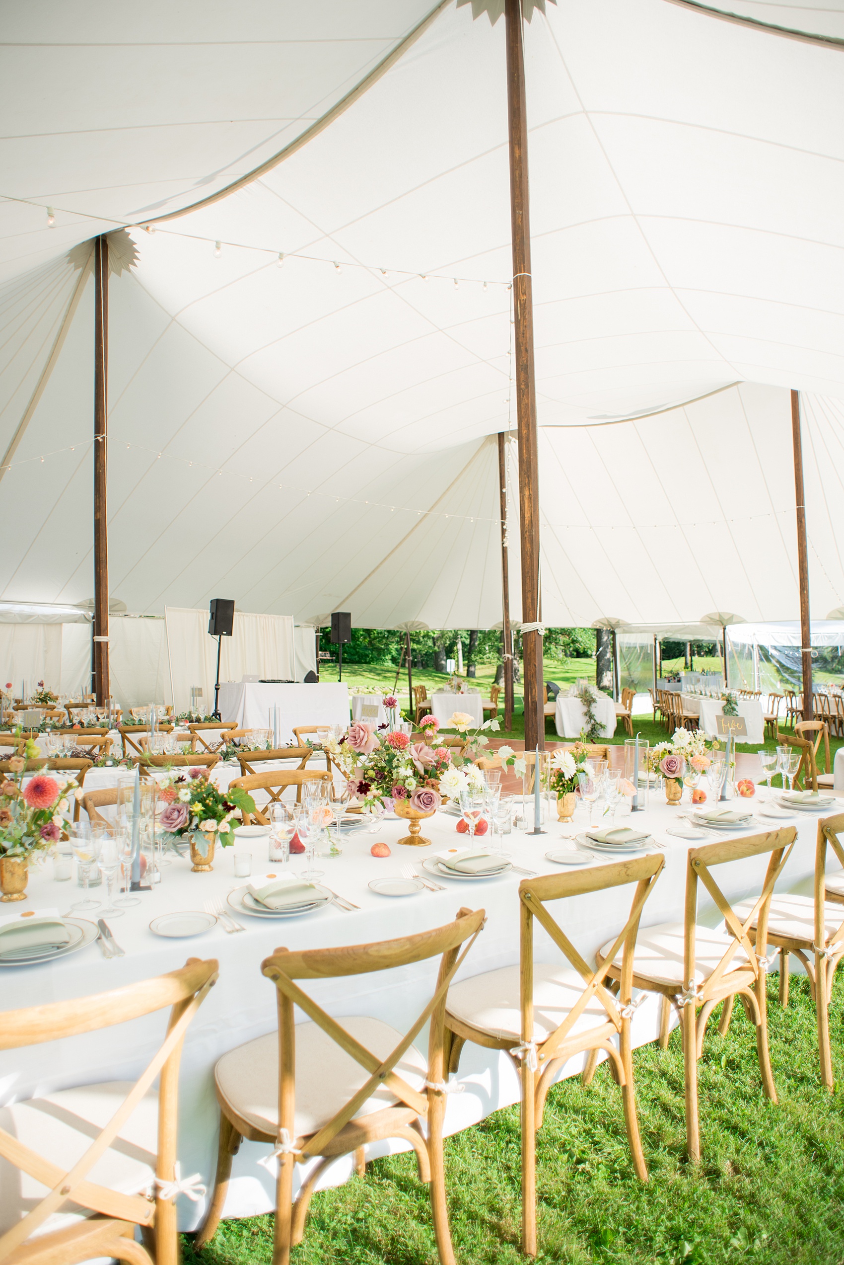 Mikkel Paige Photography photos from a Southwood Estate Wedding in Germantown, New York in the Hudson Valley. Picture of the tables with blue candles, colorful flowers and peach fruit accents.