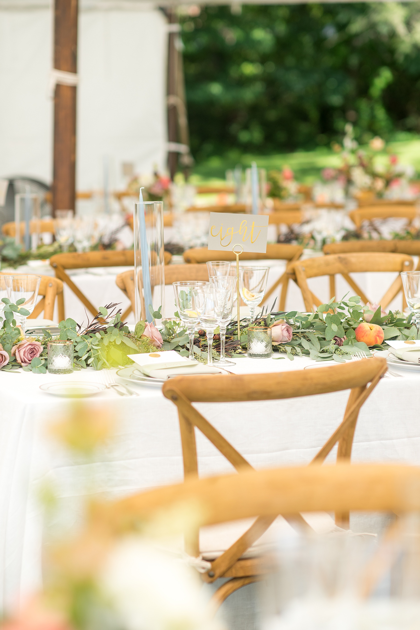 Mikkel Paige Photography photos from a Southwood Estate Wedding in Germantown, New York in the Hudson Valley. Picture of the tables with blue candles, colorful flowers and peach fruit accents.