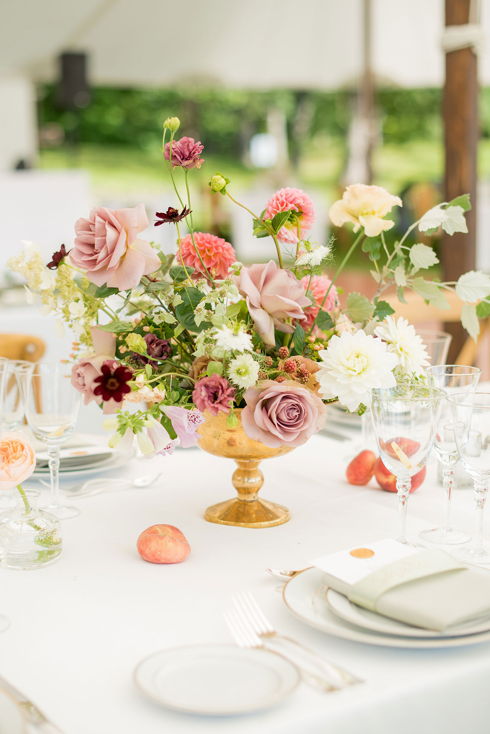 Mikkel Paige Photography photos from a Southwood Estate Wedding in Germantown, New York in the Hudson Valley. Picture of the centerpieces on a table with flowers including mauve, dusty rose, burgundy, lavender,and pink roses, dahlias, spray roses, peaches and berries.