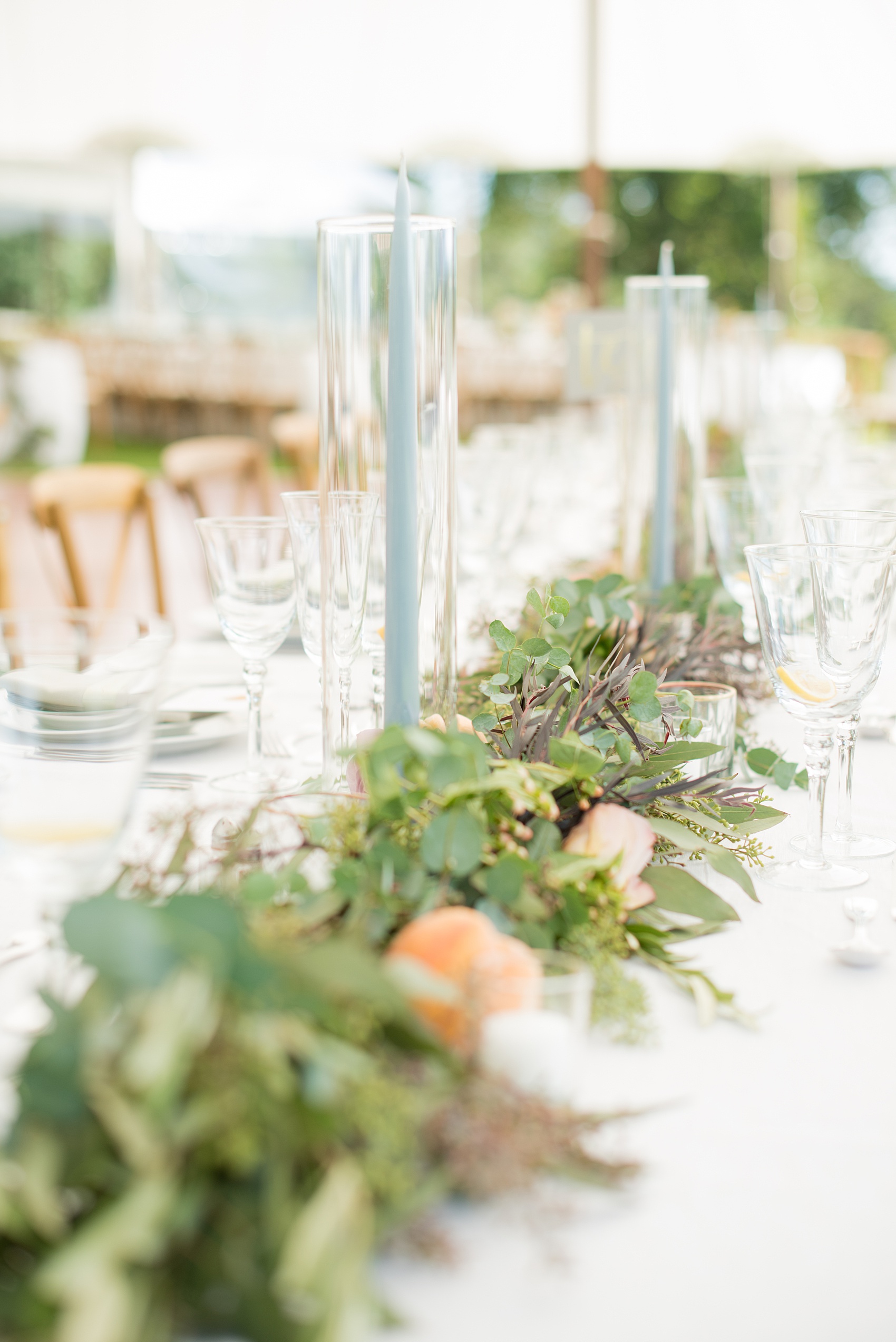 Mikkel Paige Photography photos from a Southwood Estate Wedding in Germantown, New York in the Hudson Valley. Picture of the eucalyptus garland, roses, peaches and blue tapered candles completed the tables.