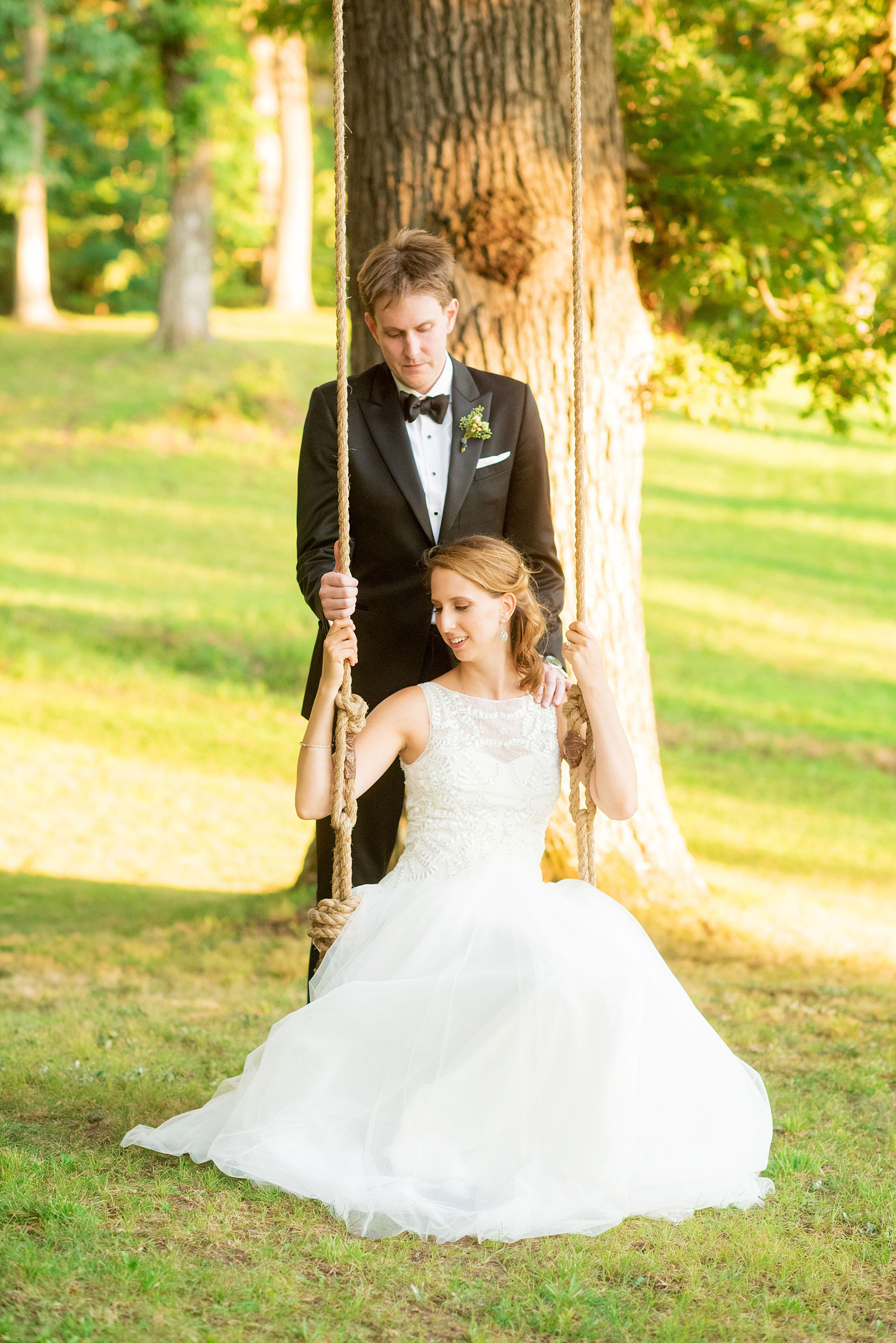 Mikkel Paige Photography photos from a Southwood Estate Wedding in Germantown, New York in the Hudson Valley. Golden hour photo of the bride and groom on a swing at the historic property.