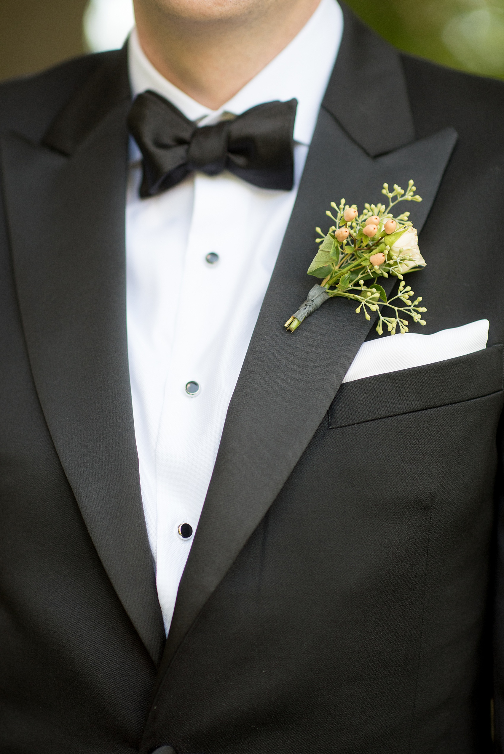 Mikkel Paige Photography photos from a Southwood Estate Wedding in Germantown, New York in the Hudson Valley. Picture of the groom's boutonniere on his classic black tuxedo.