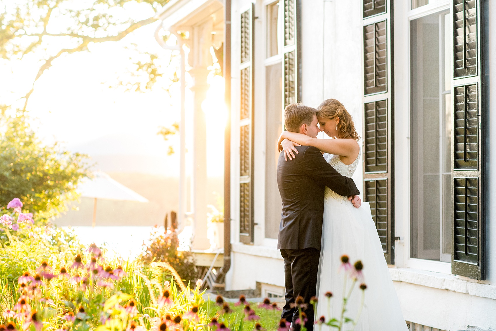Mikkel Paige Photography photos from a Southwood Estate Wedding in Germantown, New York in the Hudson Valley. Golden hour photo of the bride and groom next to the historic home.