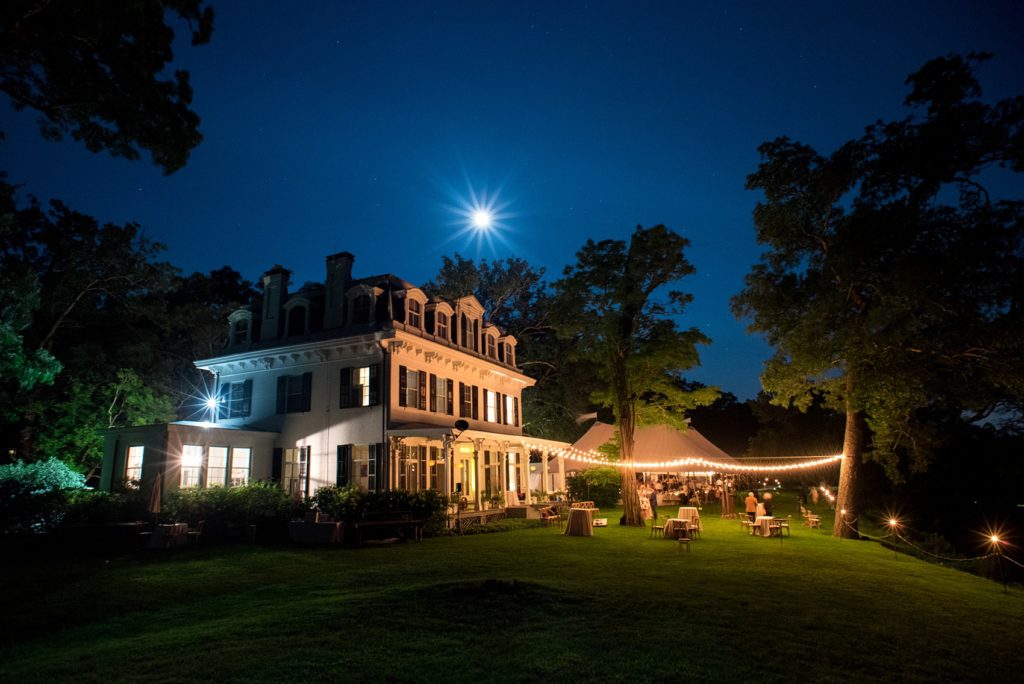 Mikkel Paige Photography photos from a Southwood Estate Wedding in Germantown, New York in the Hudson Valley. Picture of the venue at night with the moon, stars and string lights.