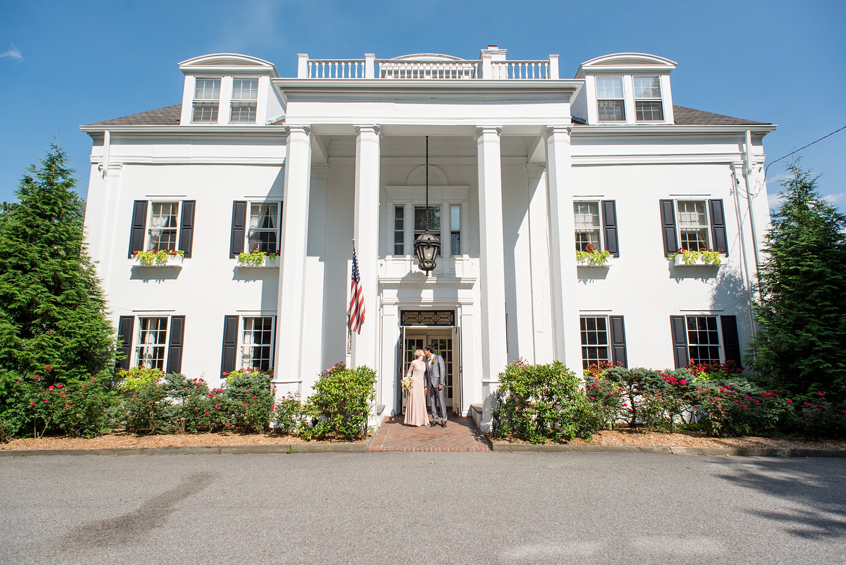 Mikkel Paige Photography photos of a wedding at Crabtree Kittle's House. Image of the bride and groom with the historic home.