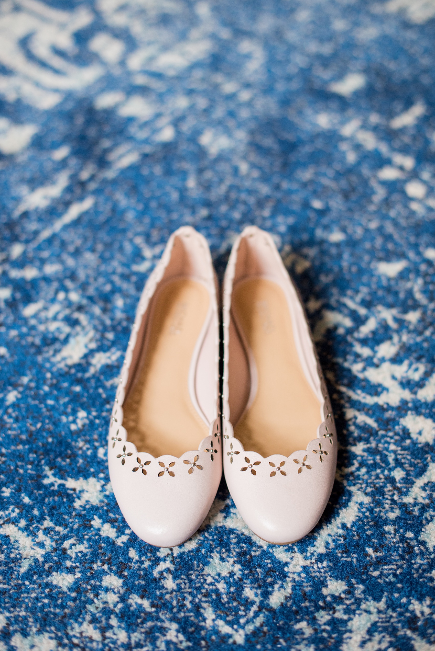 Mikkel Paige Photography photos of a wedding at Crabtree Kittle's House. Picture of the bride's pink scalloped flat shoes.