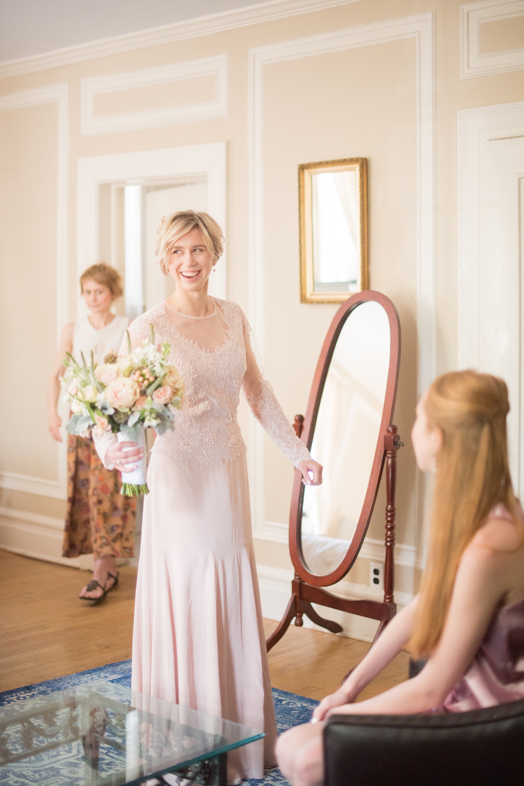 Mikkel Paige Photography photos of a wedding at Crabtree Kittle's House. Picture of the bride in her bridal suite in her custom blush, long sleeve beaded gown created by her mother.