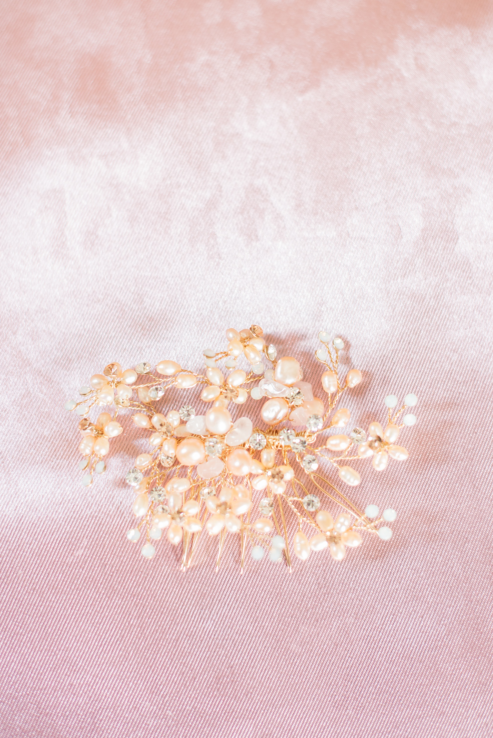 Mikkel Paige Photography photos of a wedding at Crabtree Kittle's House. Picture of the bride's pink pearl and rhinestone bridal comb.