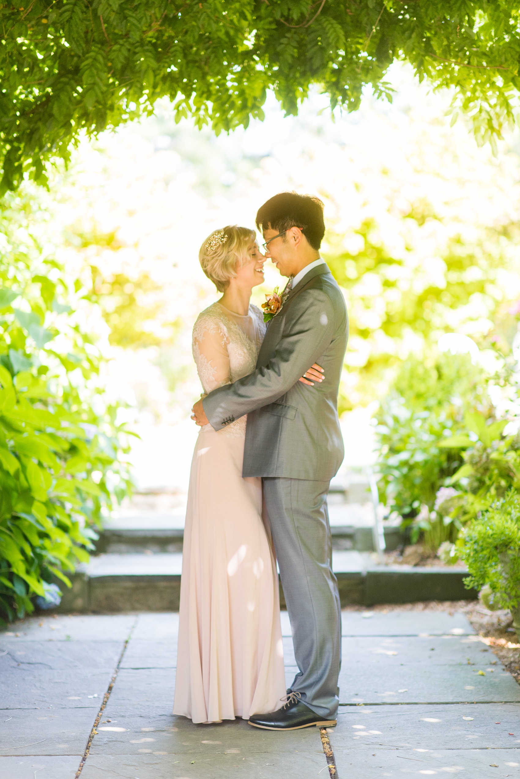 Mikkel Paige Photography photos of a wedding at Crabtree Kittle's House. Picture of the bride and groom under the decorative garden arbor.