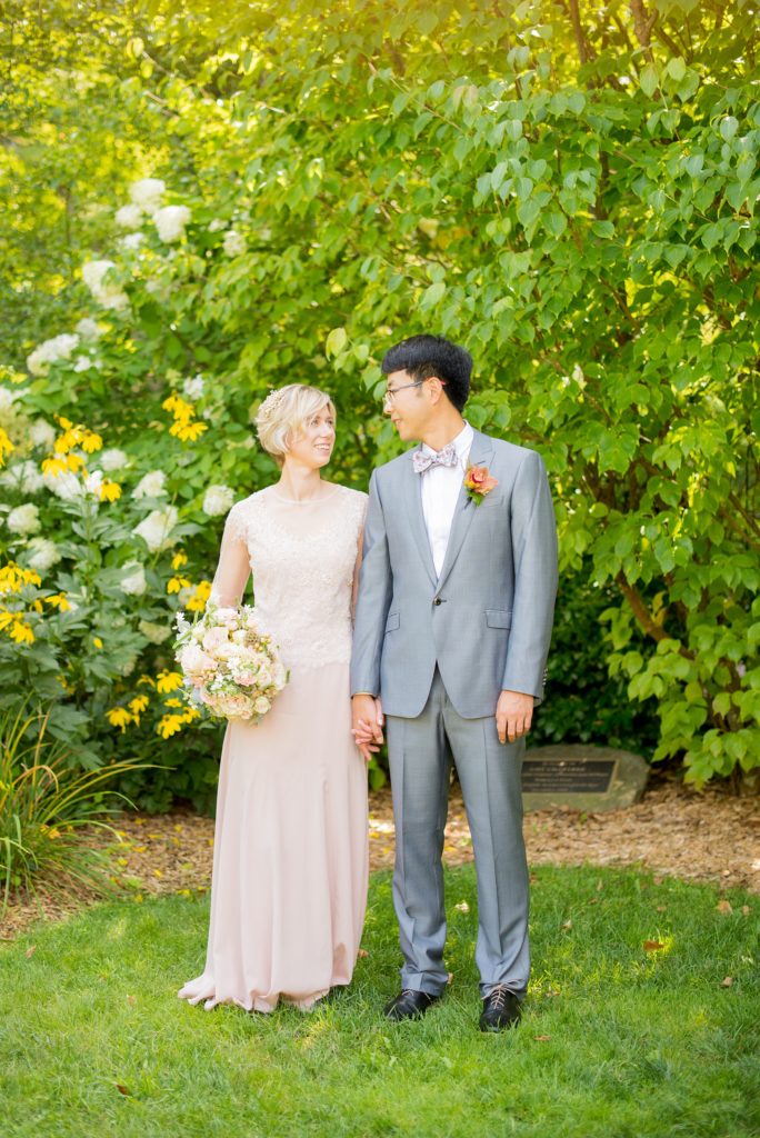 Mikkel Paige Photography photos of a wedding at Crabtree Kittle's House. Picture of the bride and groom. She wore a blush gown and he wore a grey suit.