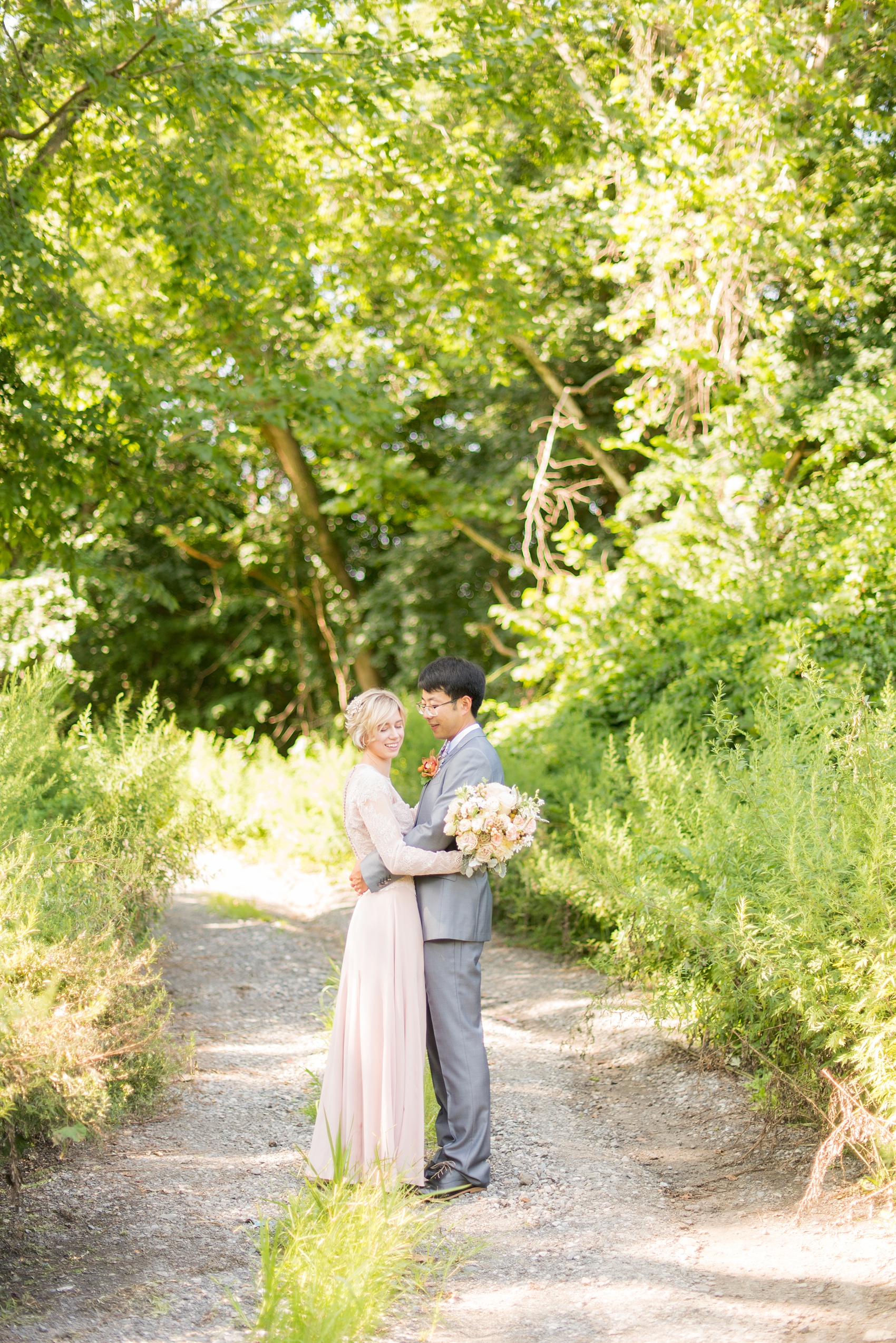 Mikkel Paige Photography photos of a wedding at Crabtree Kittle's House. Picture of the bride and groom in a grey suit and custom blush pink gown.