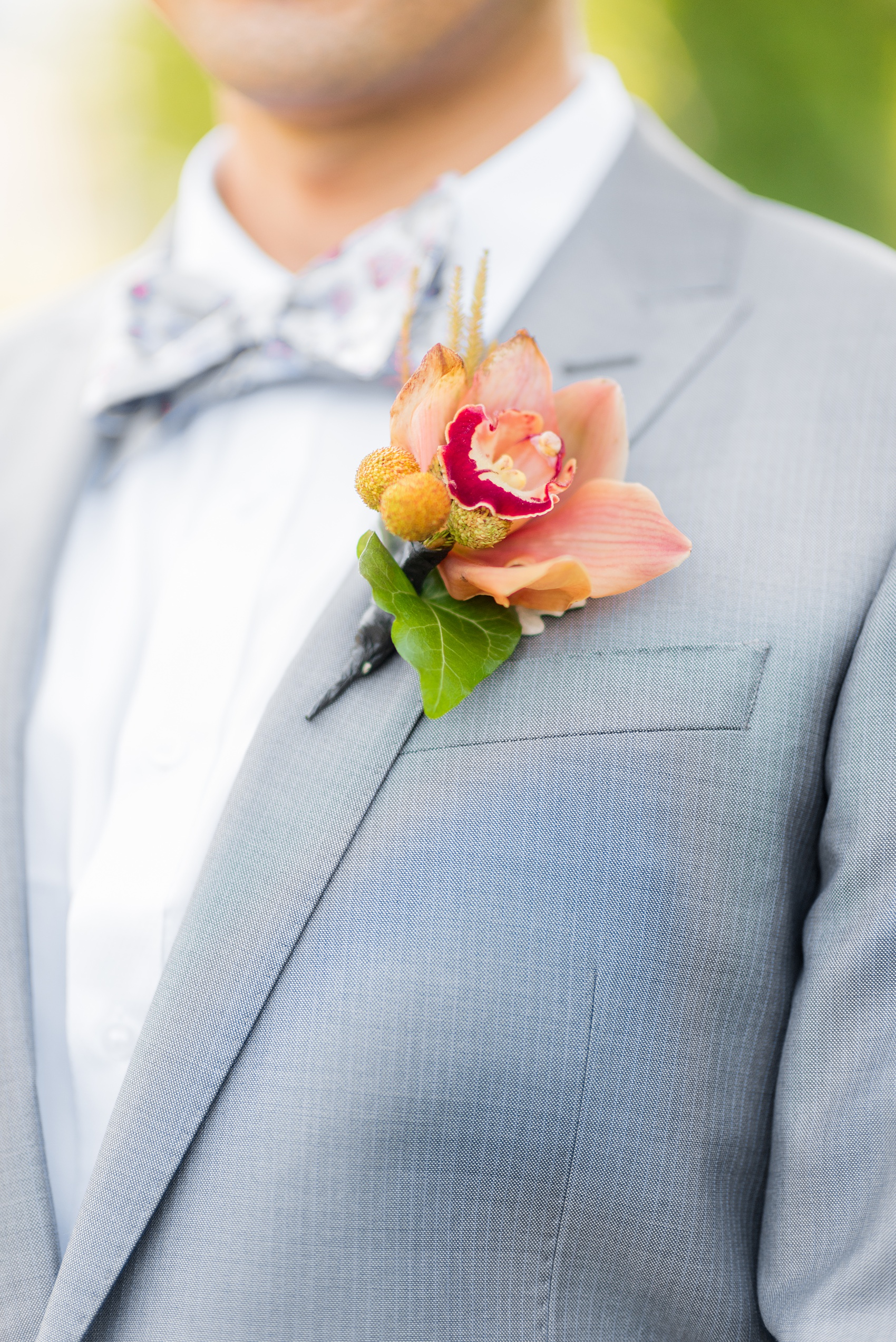 Mikkel Paige Photography photos of a wedding at Crabtree Kittle's House. Picture of the groom's orchid and brunia boutonniere.