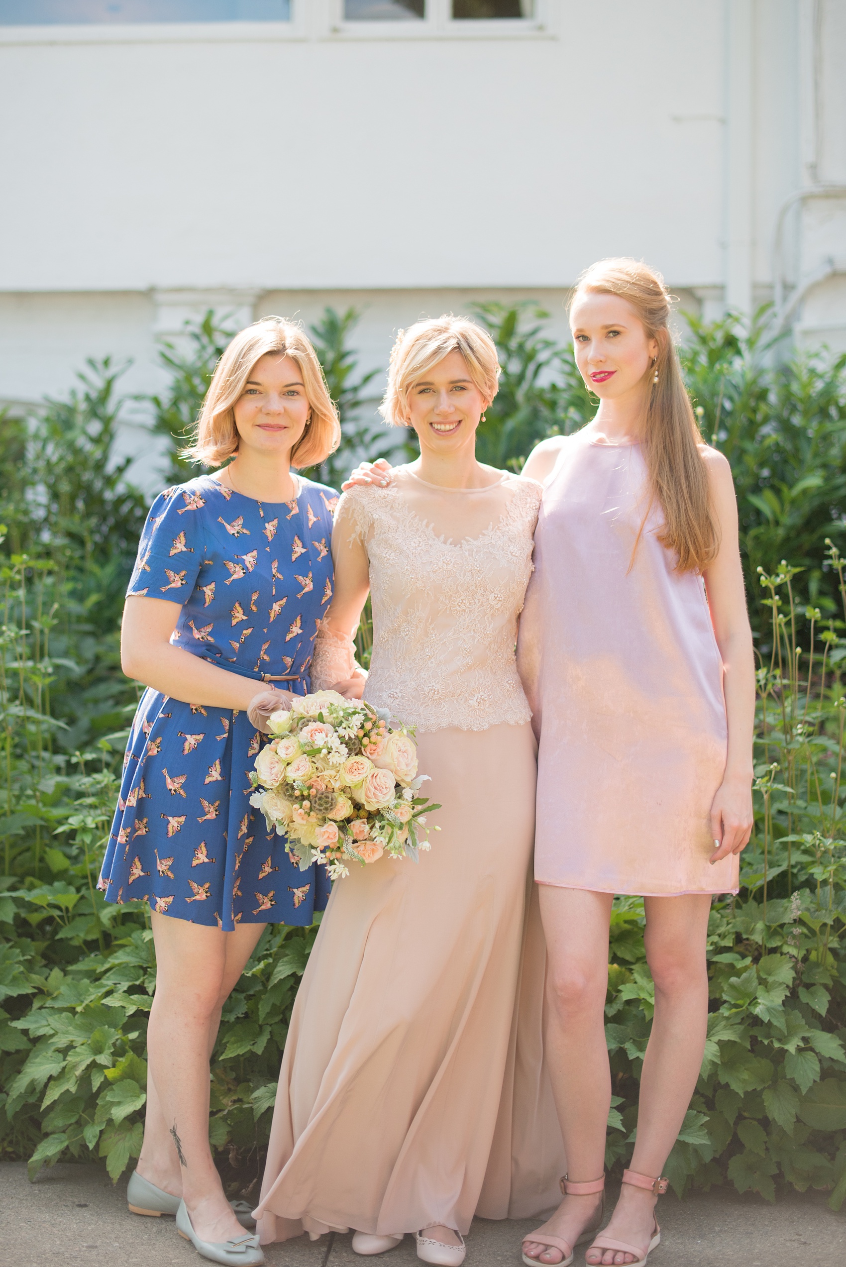 Mikkel Paige Photography photos of a wedding at Crabtree Kittle's House. Picture of the bride and her two bridesmaids in their own dresses.