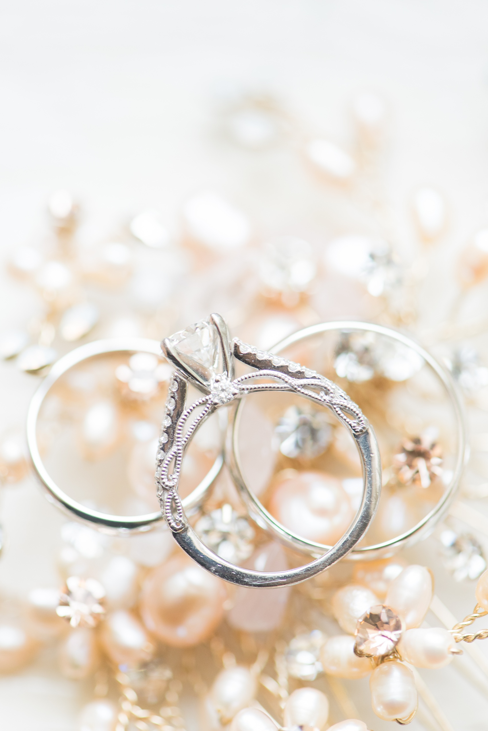 Mikkel Paige Photography photos of a wedding at Crabtree Kittle's House. Picture of the wedding rings against a pearl background.