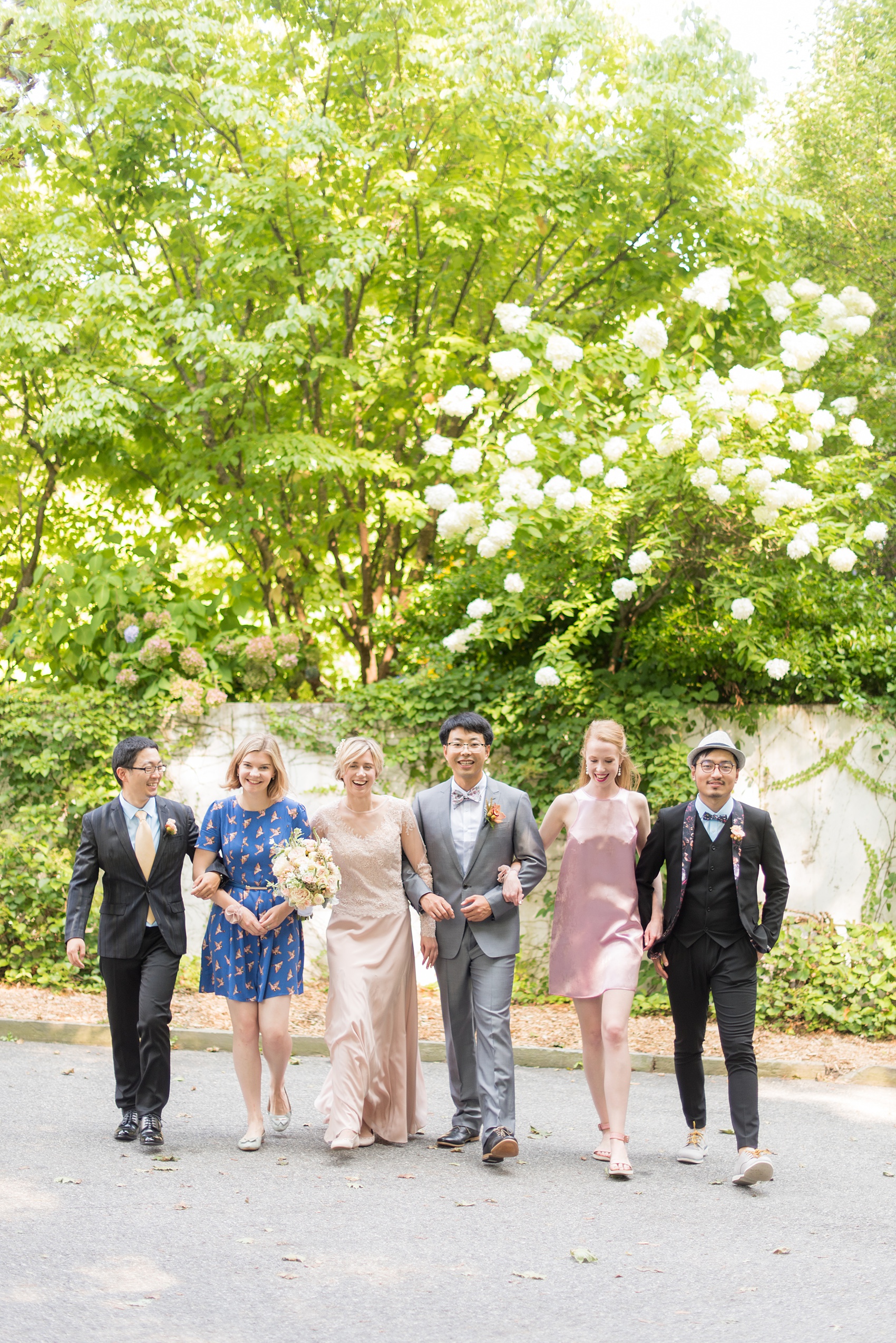 Mikkel Paige Photography photos of a wedding at Crabtree Kittle's House. Picture of the wedding party walking by the garden.