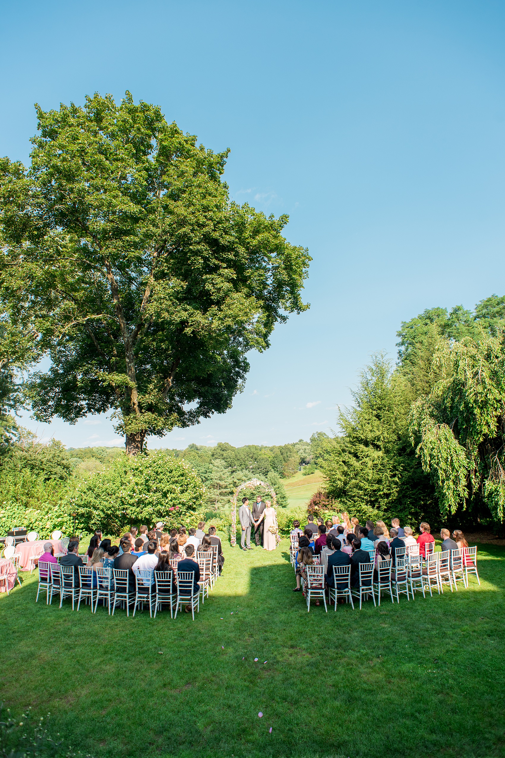 Mikkel Paige Photography photos of a wedding at Crabtree Kittle's House. Picture of the summer ceremony in the outdoor garden area.